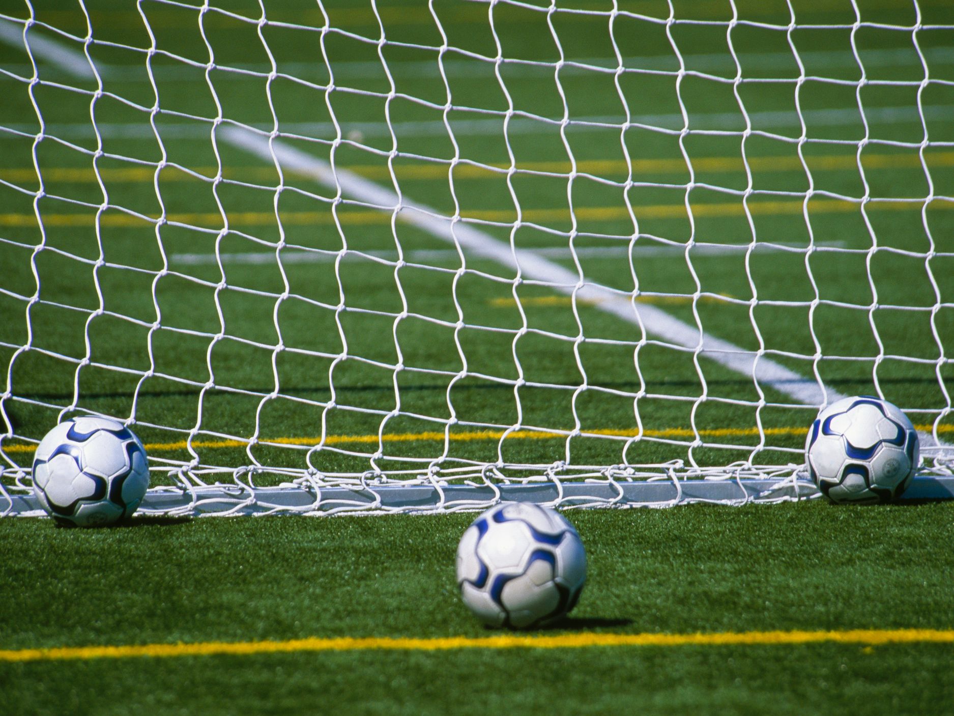 Soccer balls on pitch.
