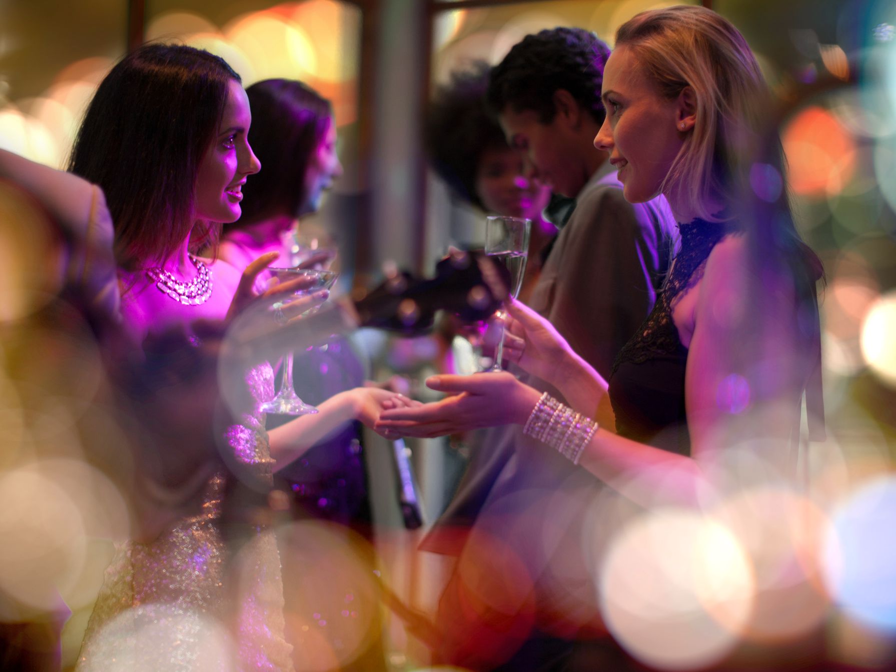 Friends talking at a social event.