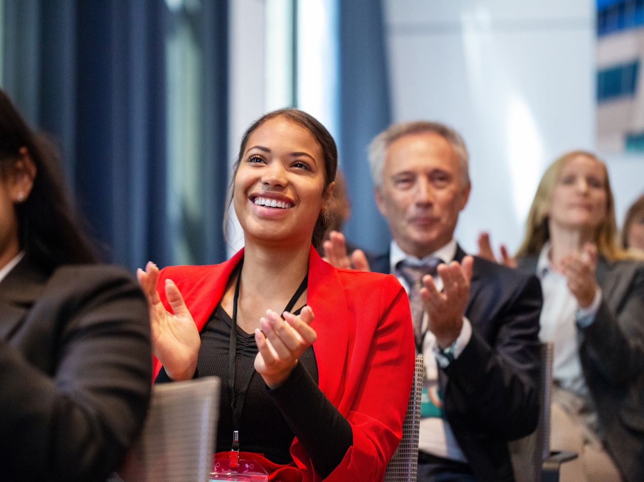 people clapping in the audience of a conference