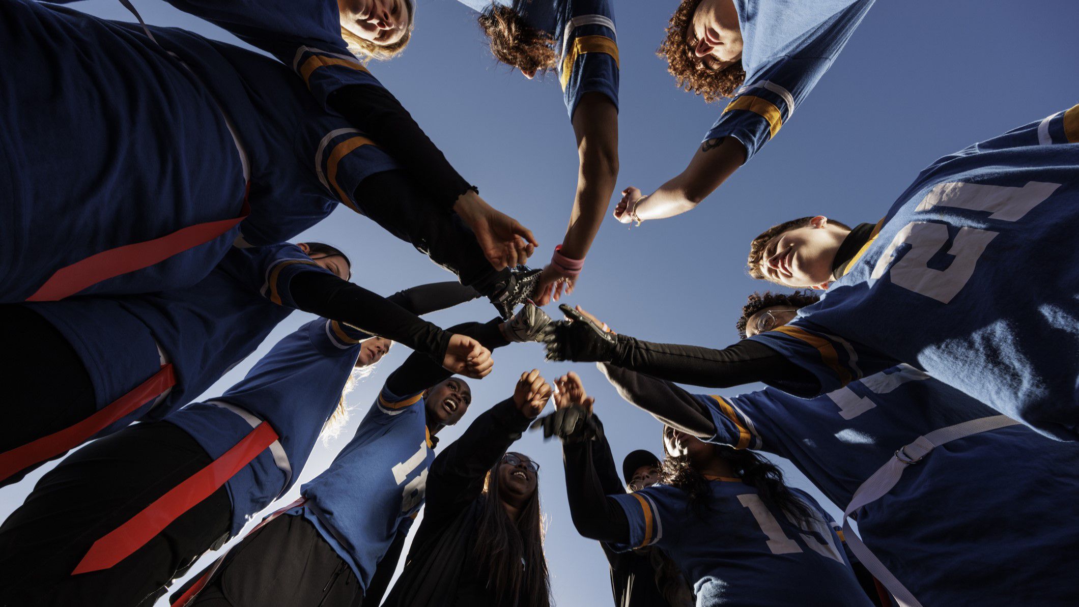 Football team putting their hands together