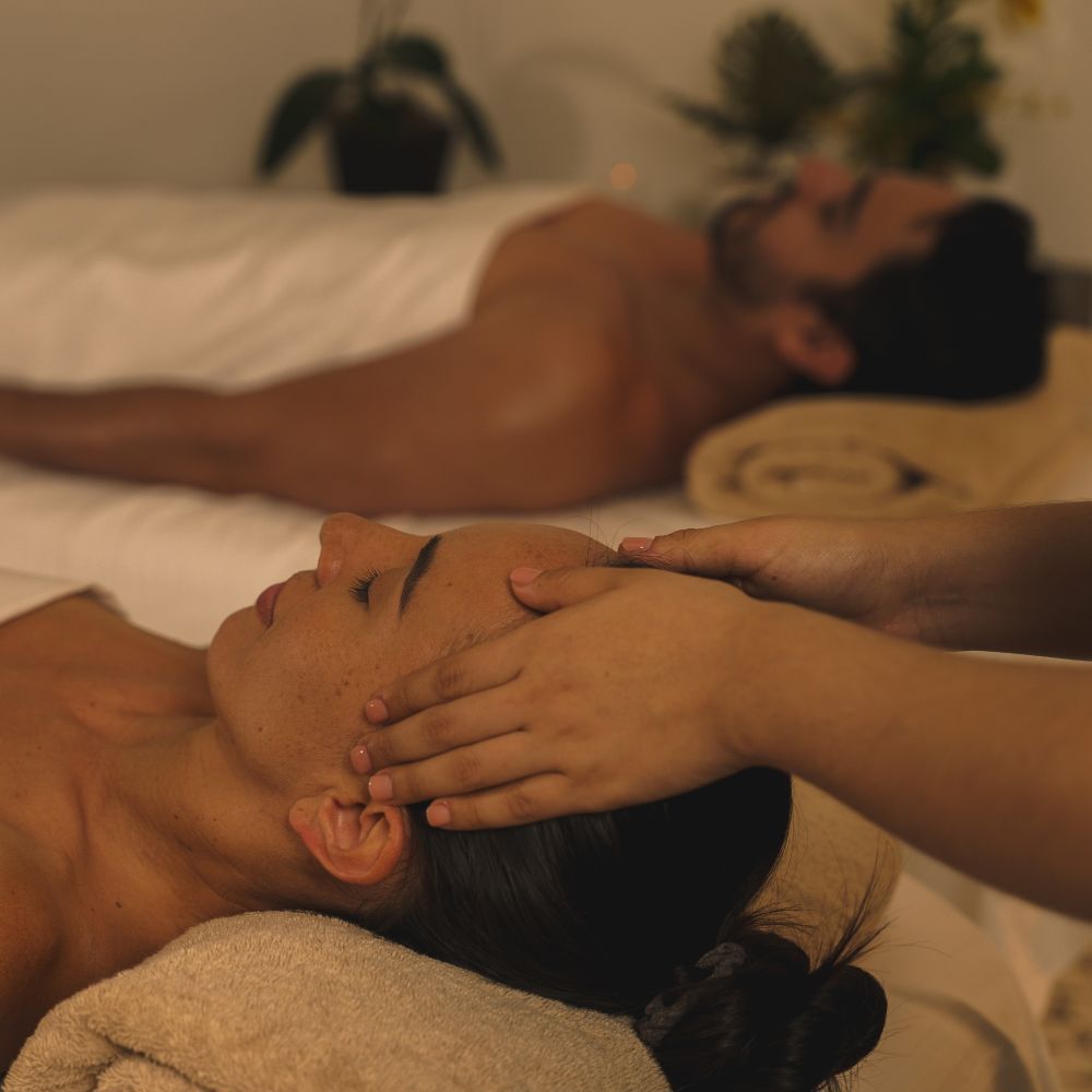 Couple relaxing in spa getting couples massage