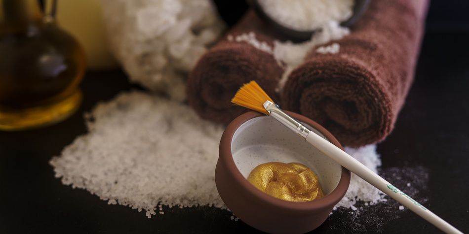 Luxury spa scrub with brush, towels, and bath salts