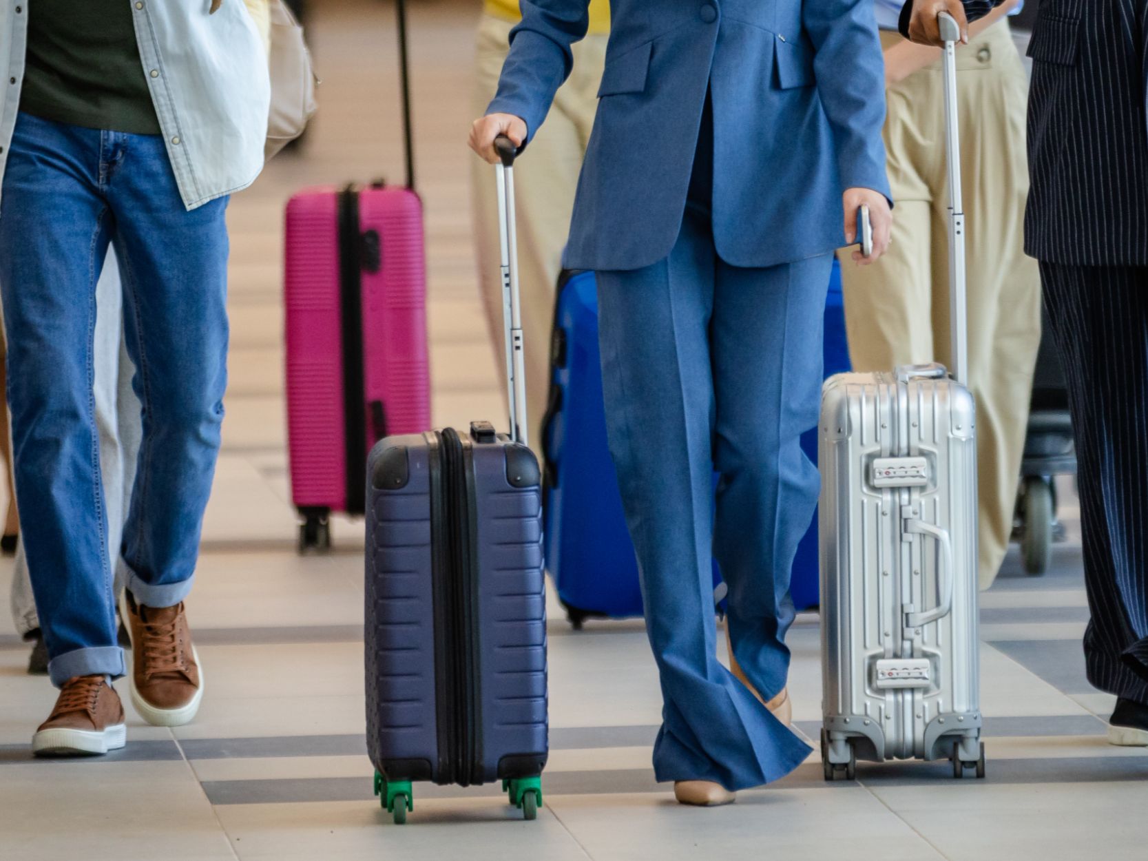 A group of people walking through the airport. 
