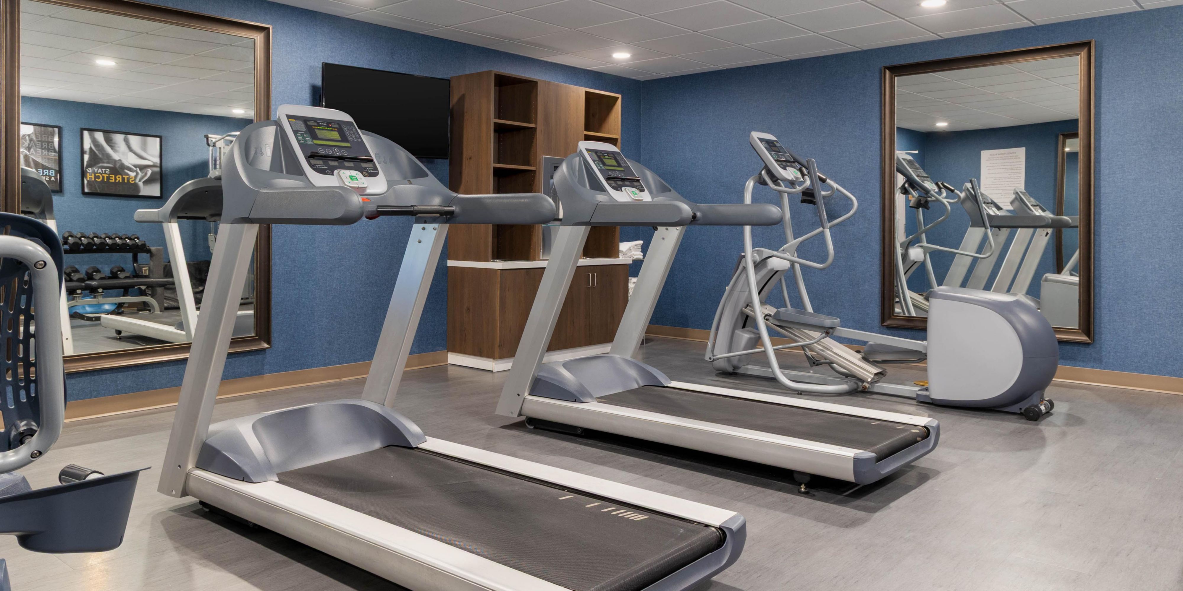 Fitness center with cardio machines and weights.