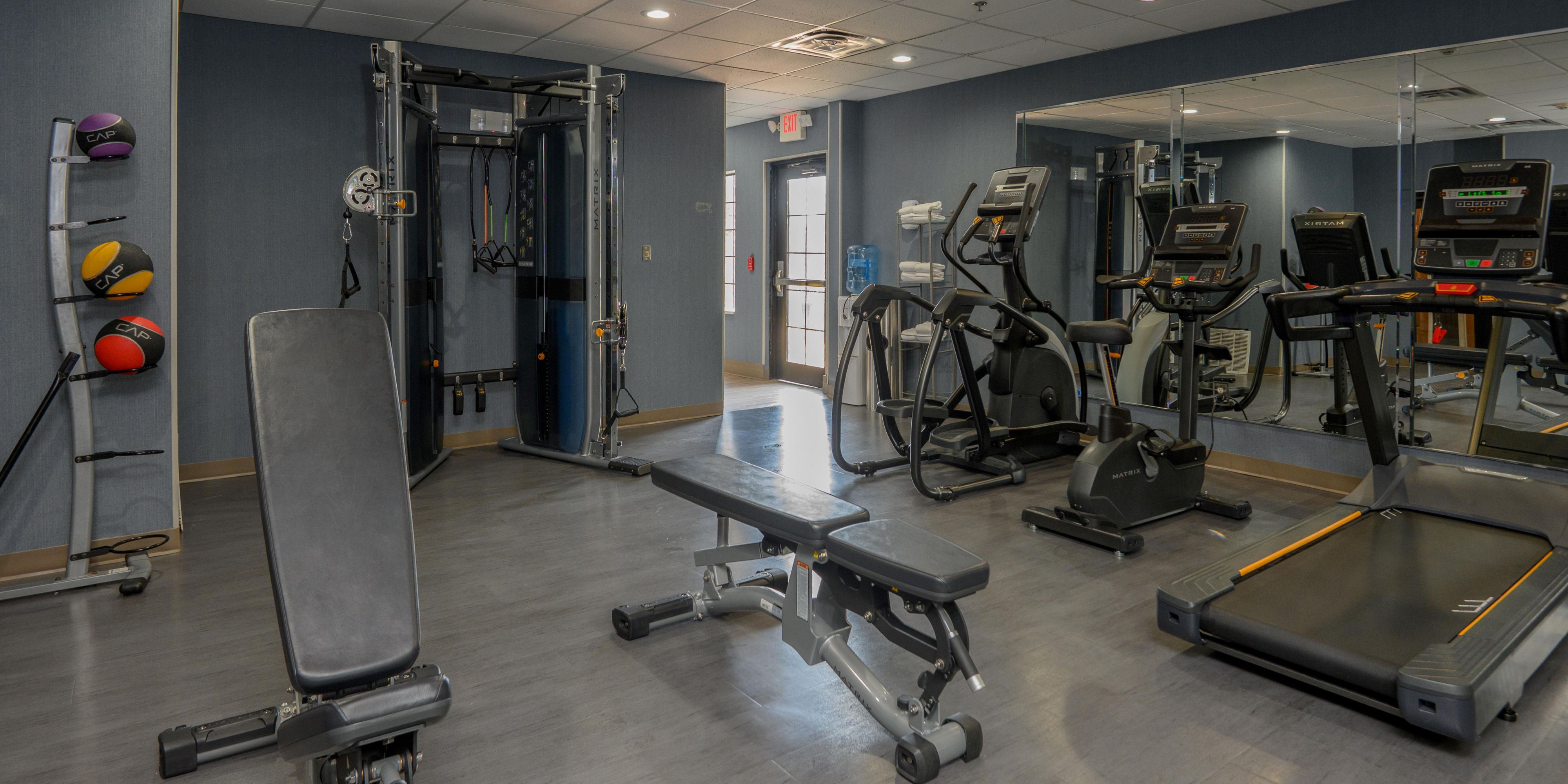 24/7 fitness center with treadmills, weights, yoga mats, and more