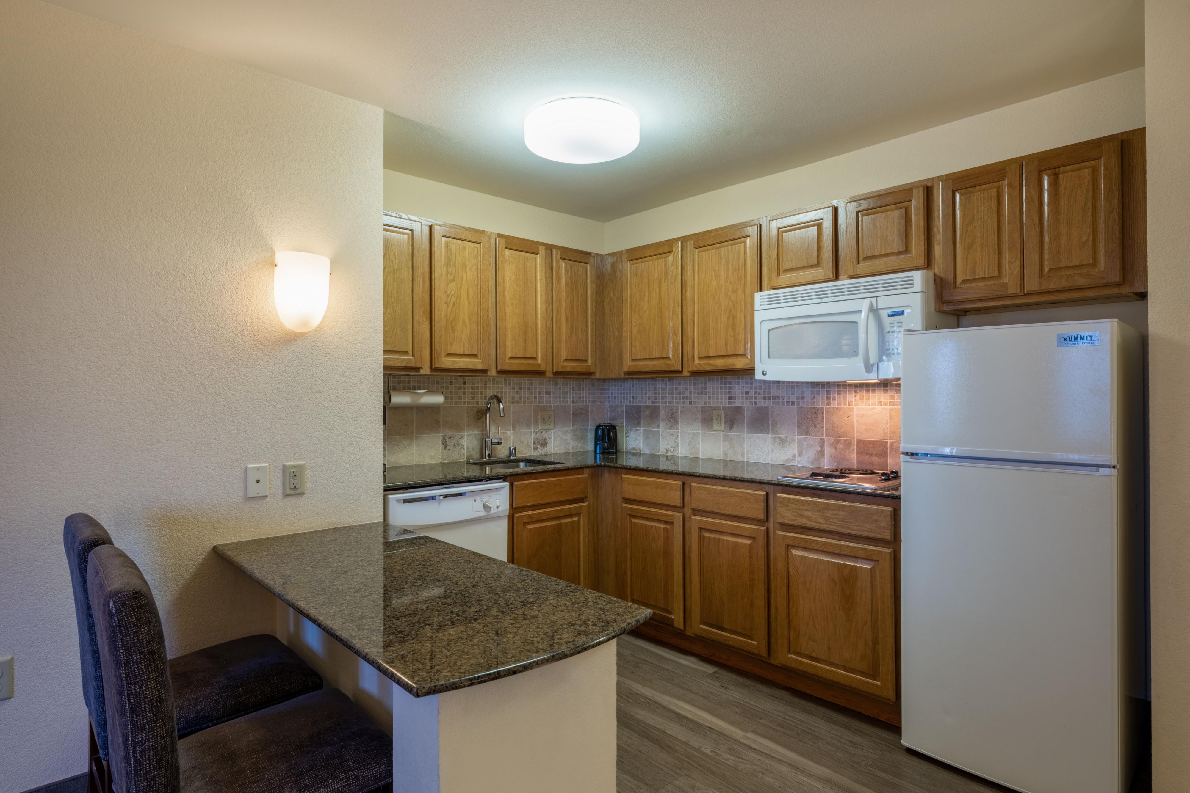 Fully equipped kitchens in each room allow guests the flexibility to cook their own meals, complete with a two-burner stovetop, microwave, full-size refrigerator, and dishwasher.