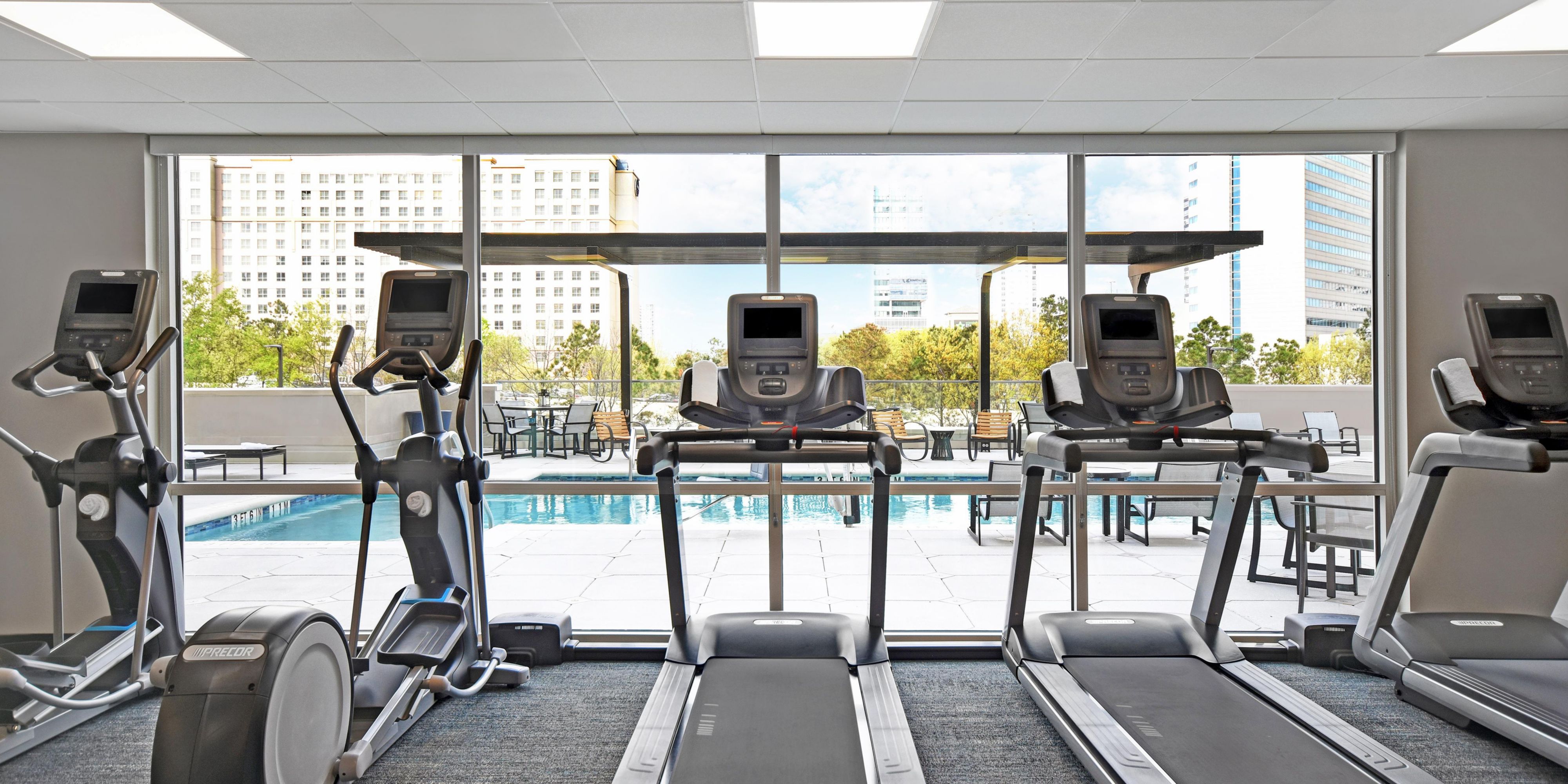 Spacious fitness center with cardio machines and free weights