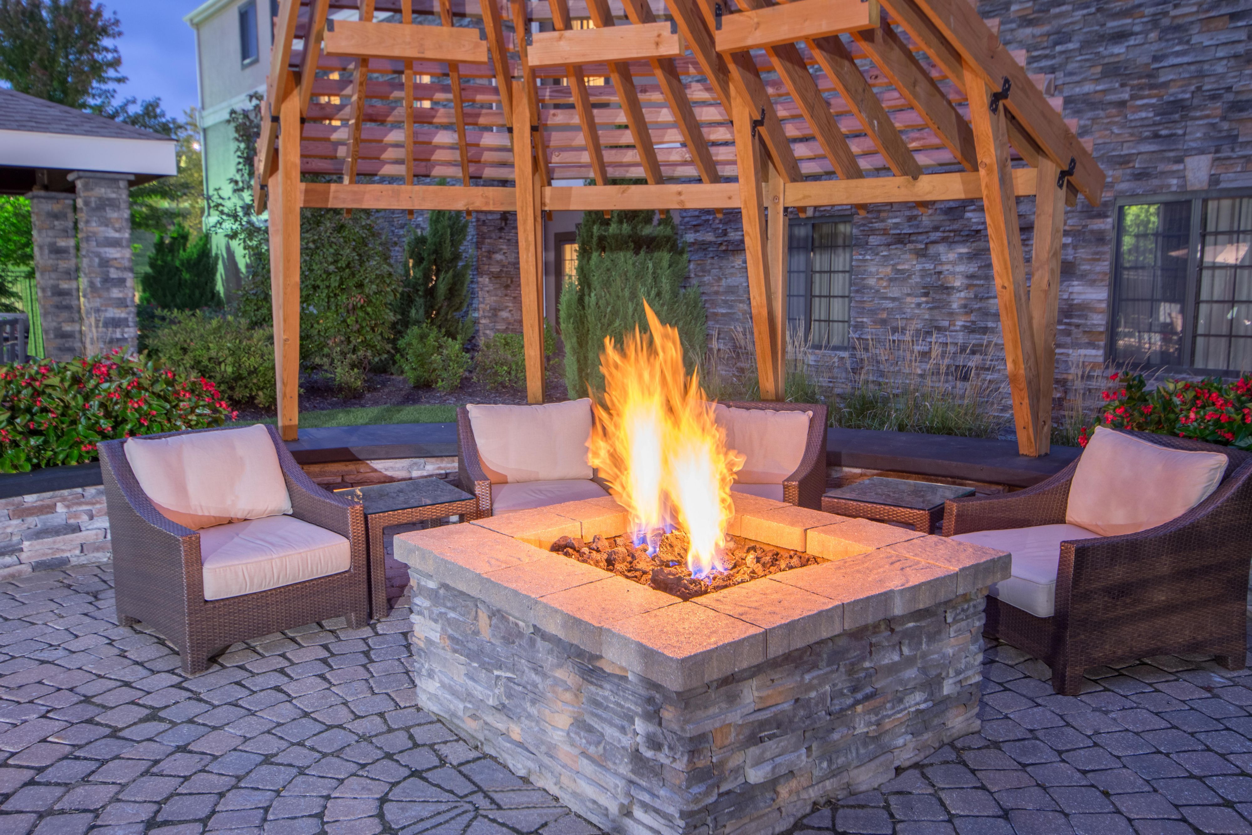 Our Courtyard allows our guests to unwind after a long day. Enjoy a roaring fire pit, with multiple relaxing seating areas. Guests can enjoy a hardy meal on any one of our three grills; propane and charcoal. 
Social Distancing enforced.