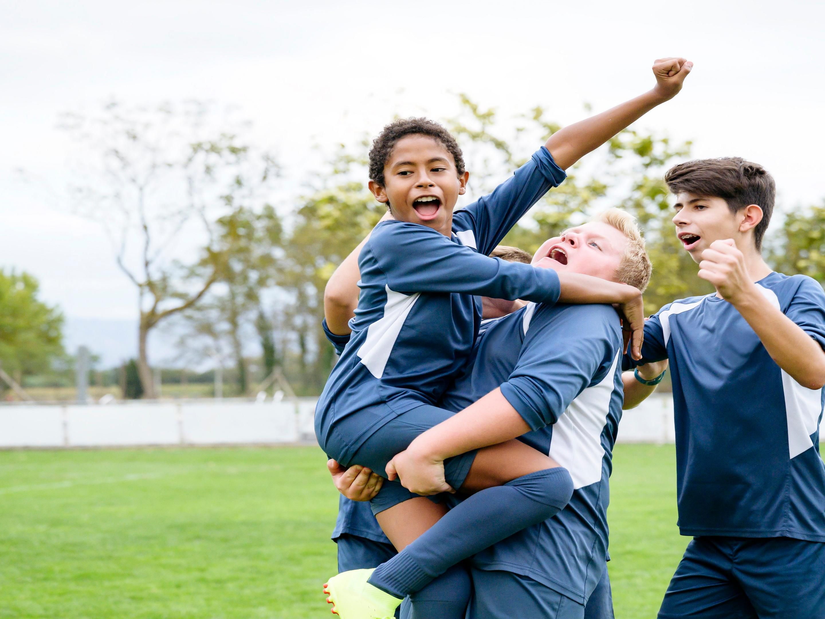 Youth soccer team celebrating a win