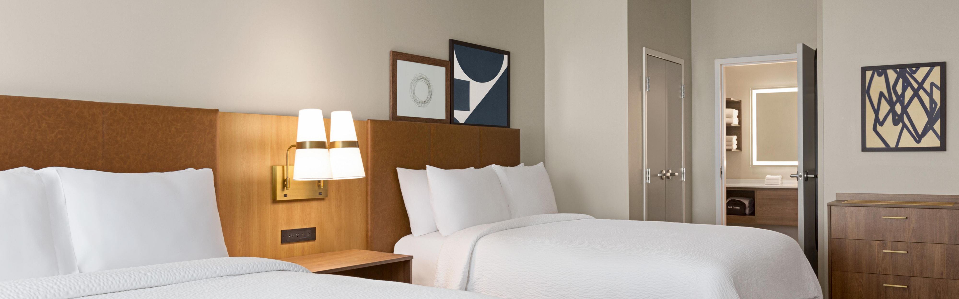 Two double beds in a hotel room