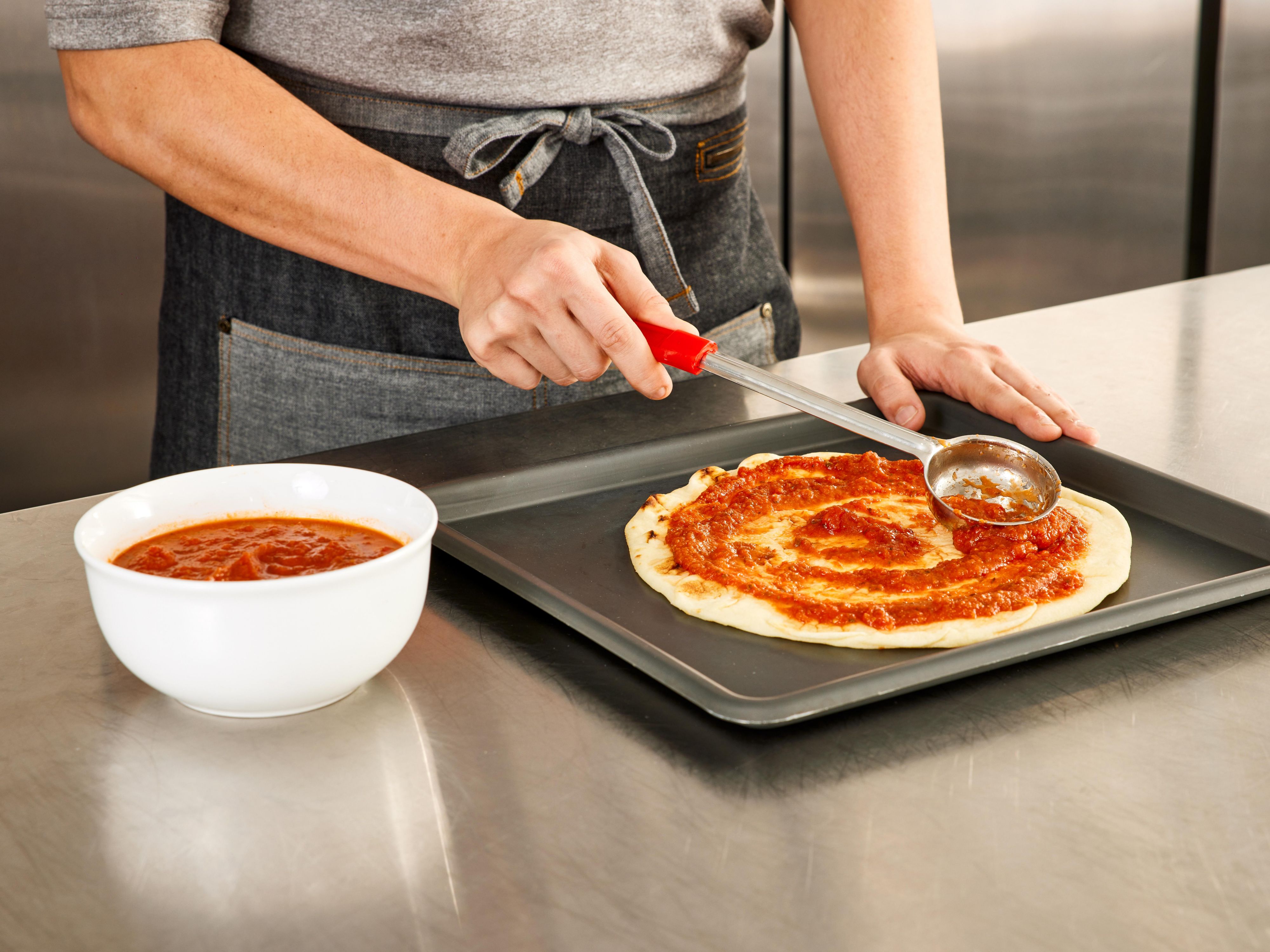 Chef preparing a personal pizza
