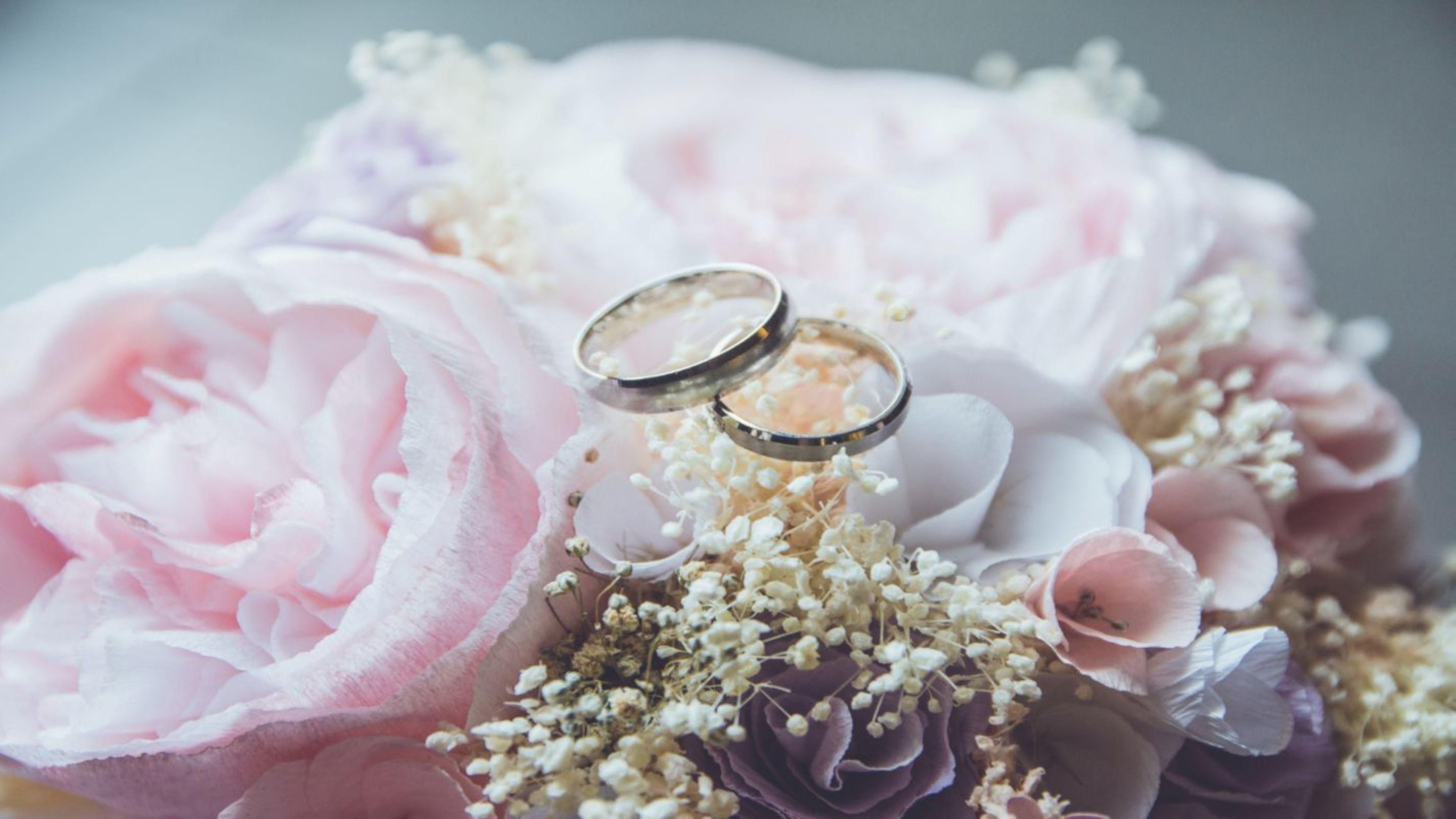 Wedding rings resting on flowers