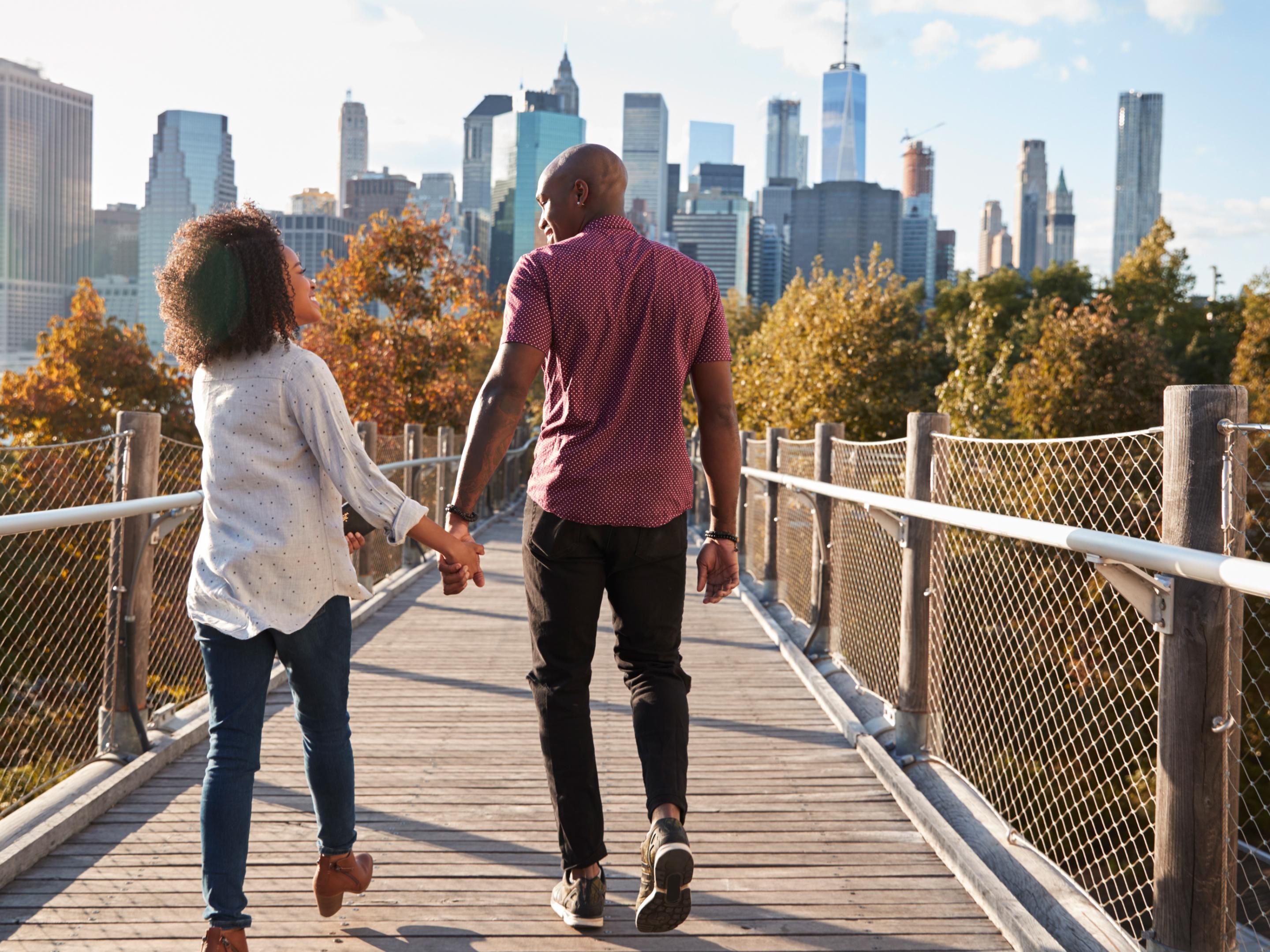 Couple walking along a bridge