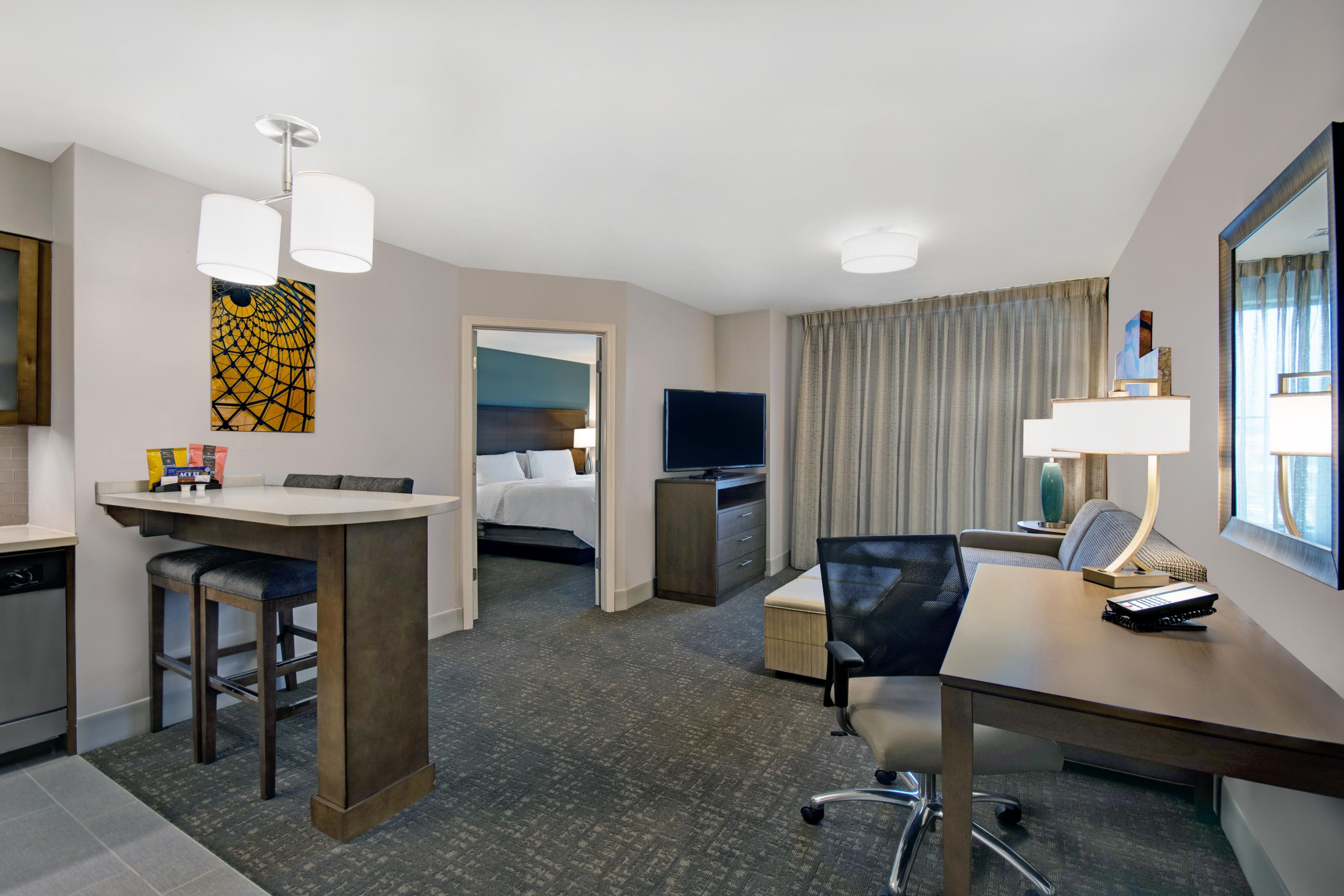 Experience the comfort of condo-style living in our spacious suites, each featuring a fully equipped kitchen. Cook with ease using an induction stovetop, microwave, full-size fridge with freezer, dishwasher, and a complete set of cookware. Designed for convenience, our suites offer a modern, home-like atmosphere for a truly comfortable stay.