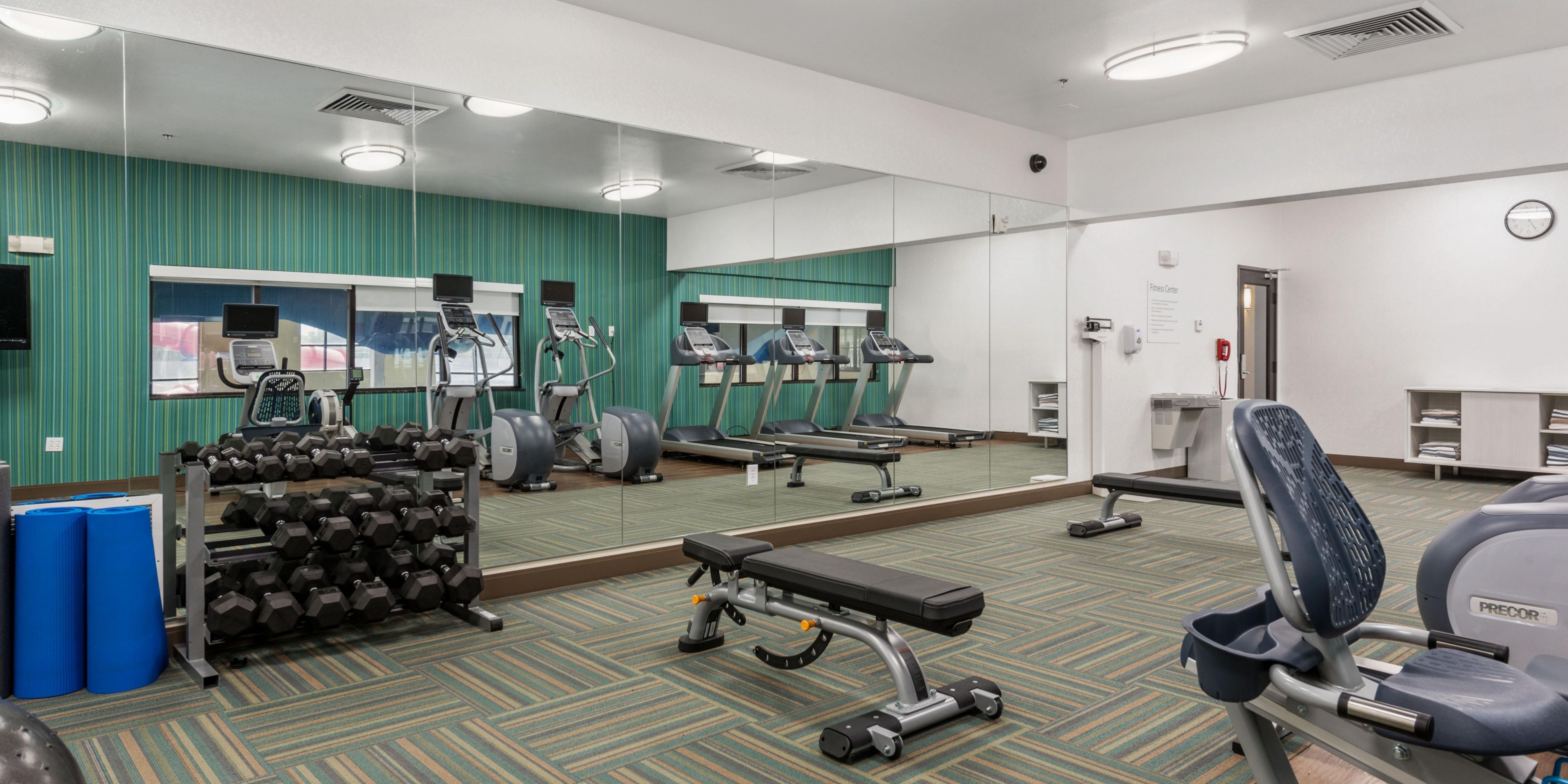The fitness center is equipped with a variety of cardio machines.
