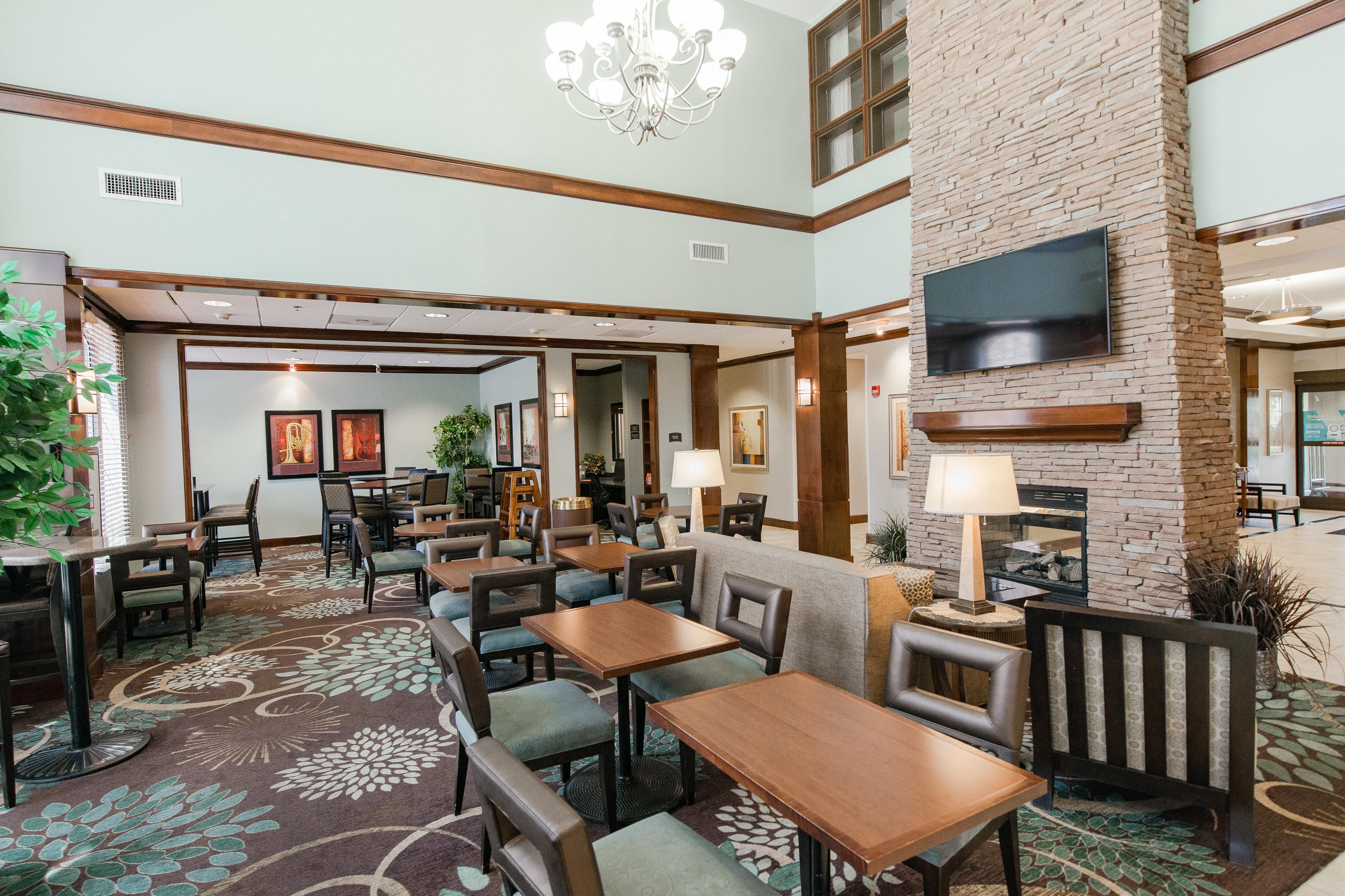 Floor decals located at Front Desk area and Dining area along with spaced seating.