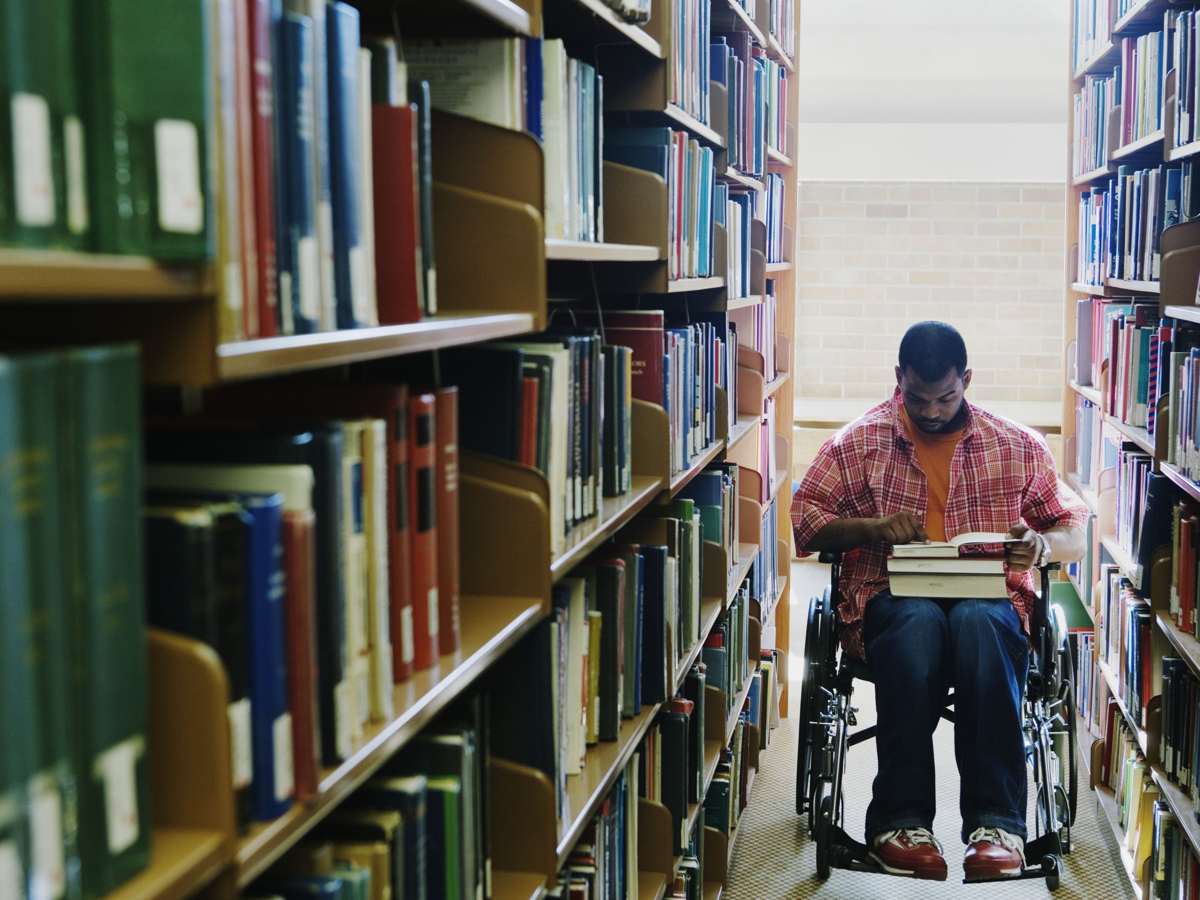 Student in wheelchair at the library.