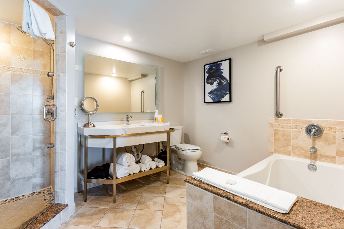 Suite bathroom with walk-in shower and bath tub