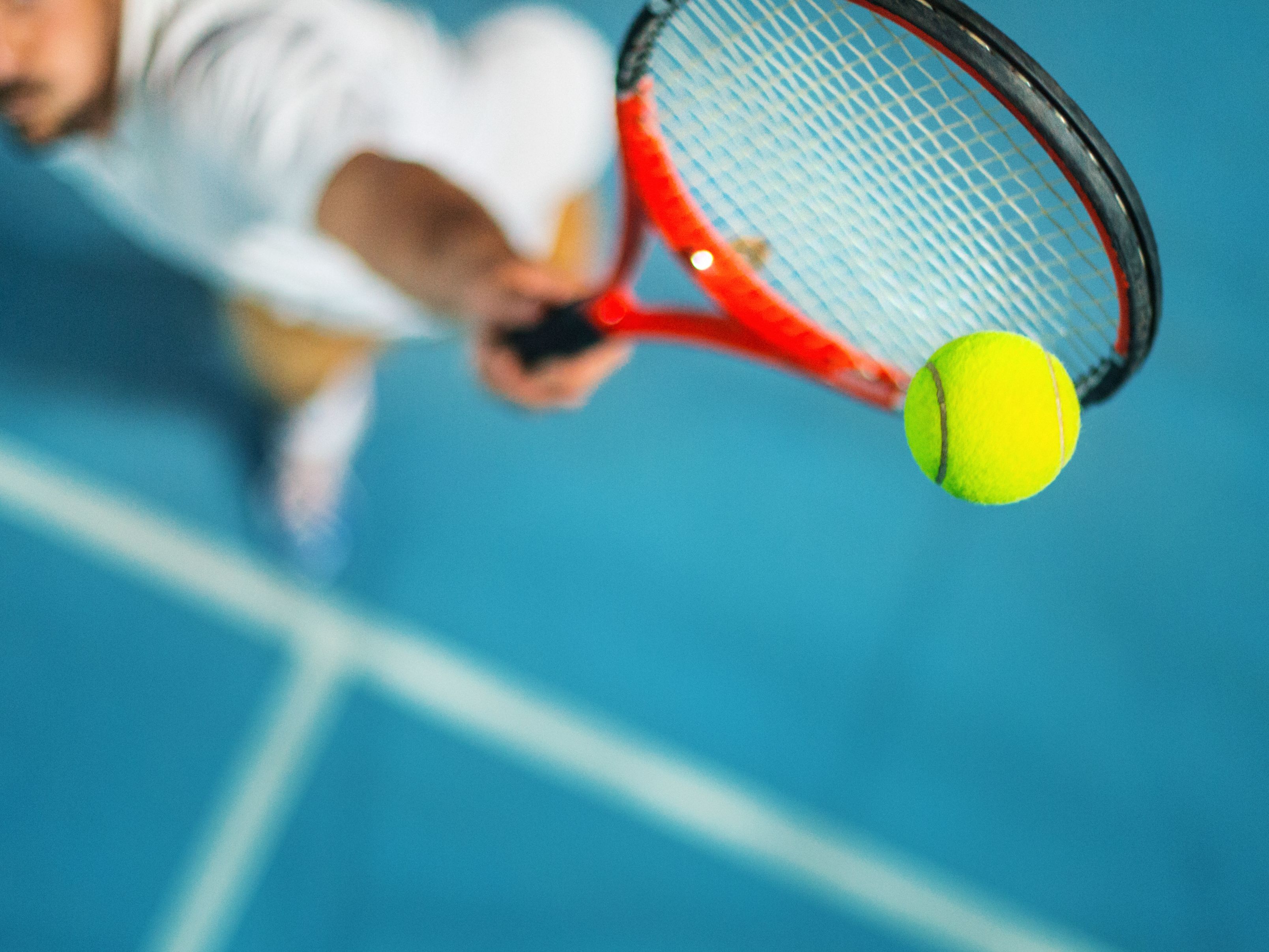 Tennis player hitting ball