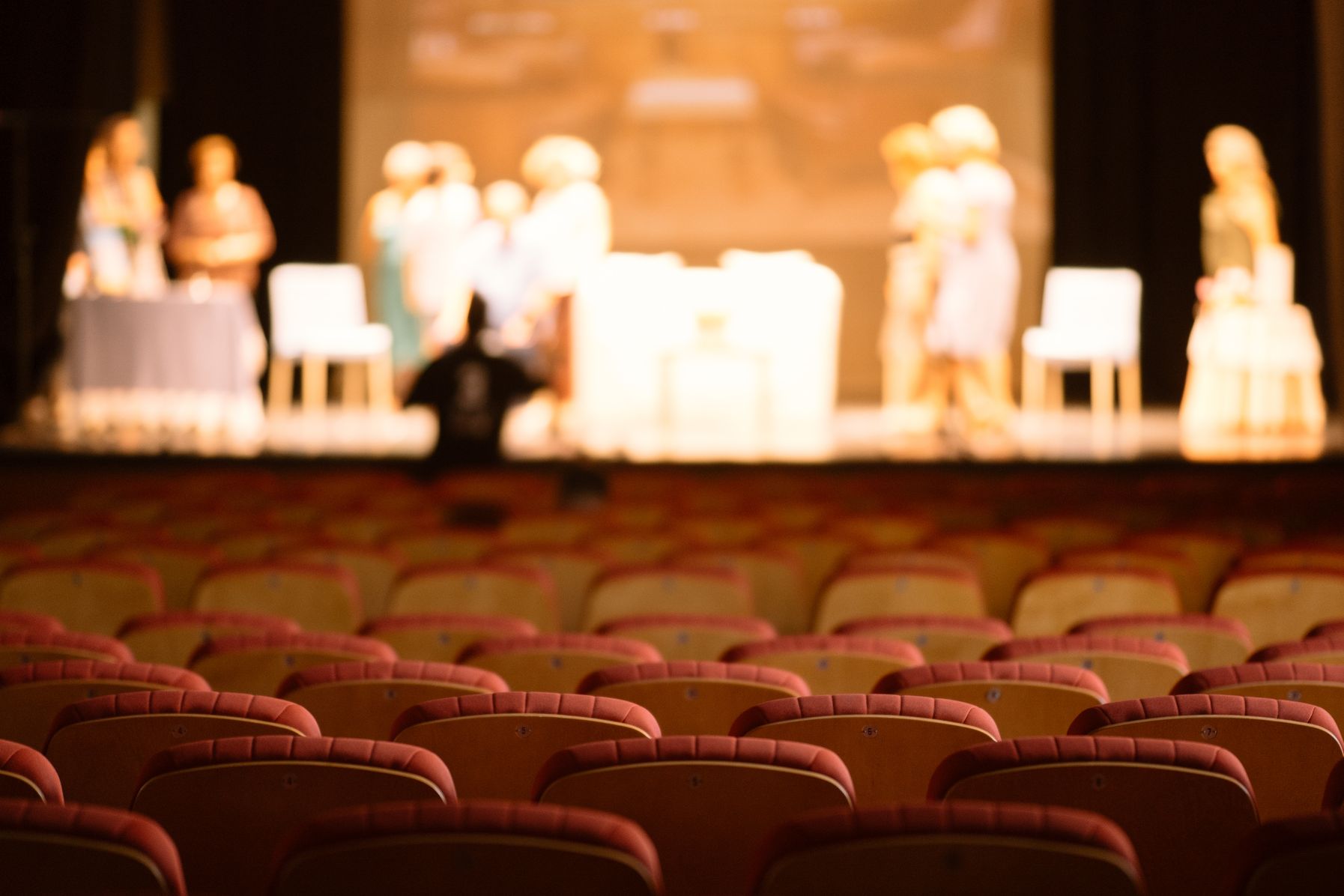 Actors on stage in a theater.