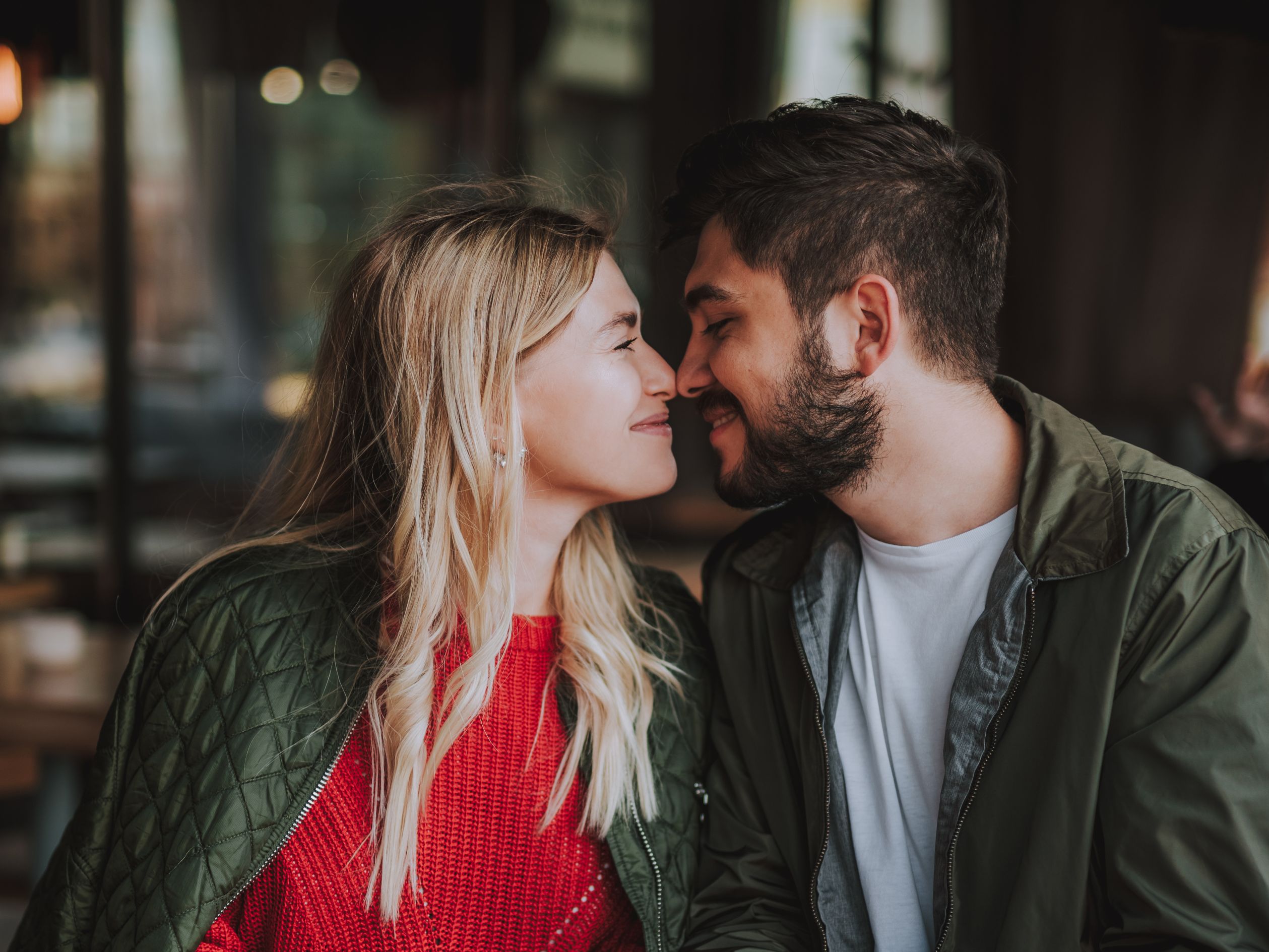 Couple embracing at table during Valentine's dinner.