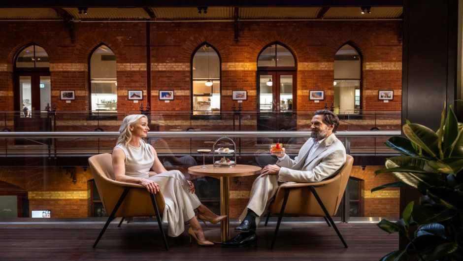 Man and woman sitted at the lobby and drinking cocktail 
