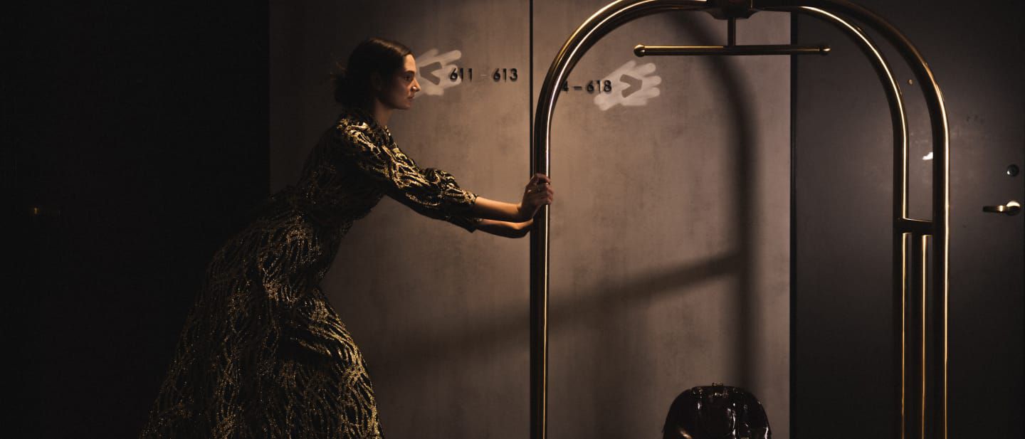 woman pushing a luggage cart
