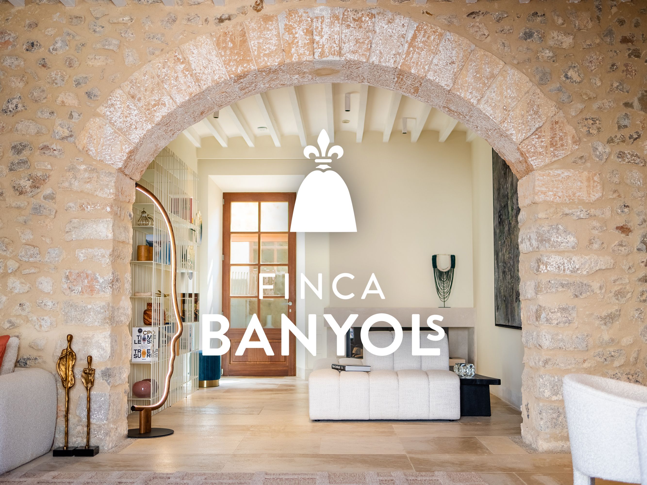 Stone archay framing modern interior at Finca Banyols