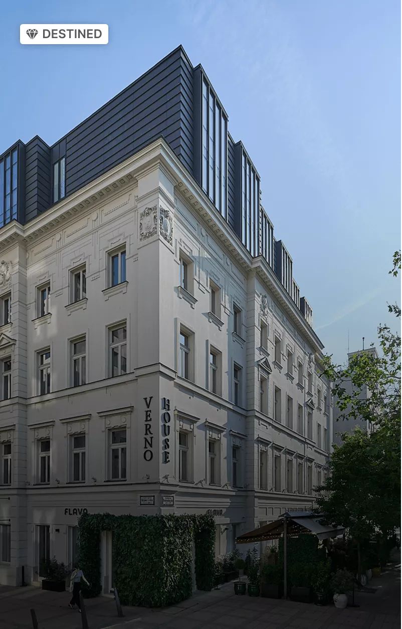 Destined property designation on an image of the cream facade and slate roof of the Vignette Collection Verno House Budapest.