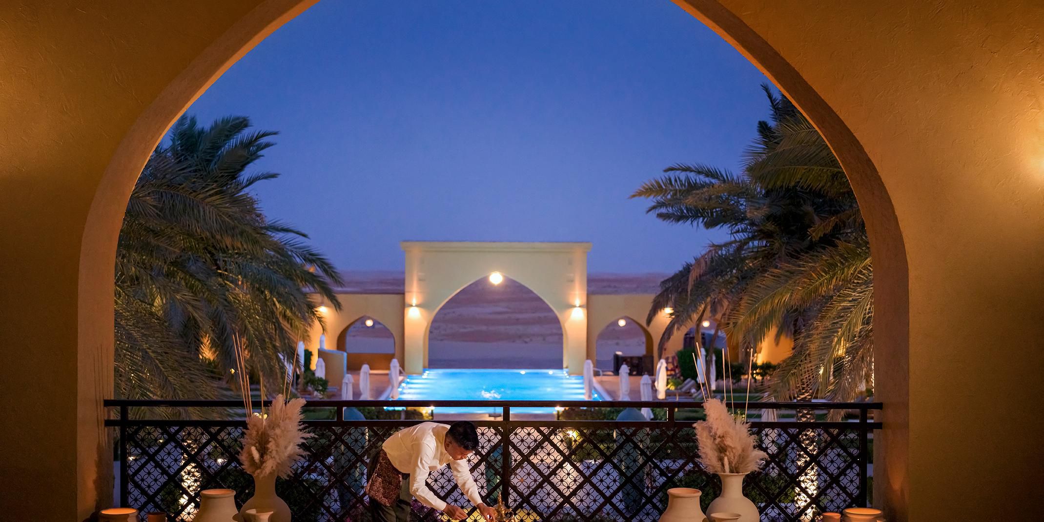 As the sun dips below the vast horizon of the Liwa desert, guests are welcomed with a complimentary serving of aromatic Arabic coffee paired with sweet, locally harvested Liwa dates. Settle into the serene majlis-style seating, adorned with plush cushions and traditional woven rugs, and let the tranquil desert breeze complete this experience.