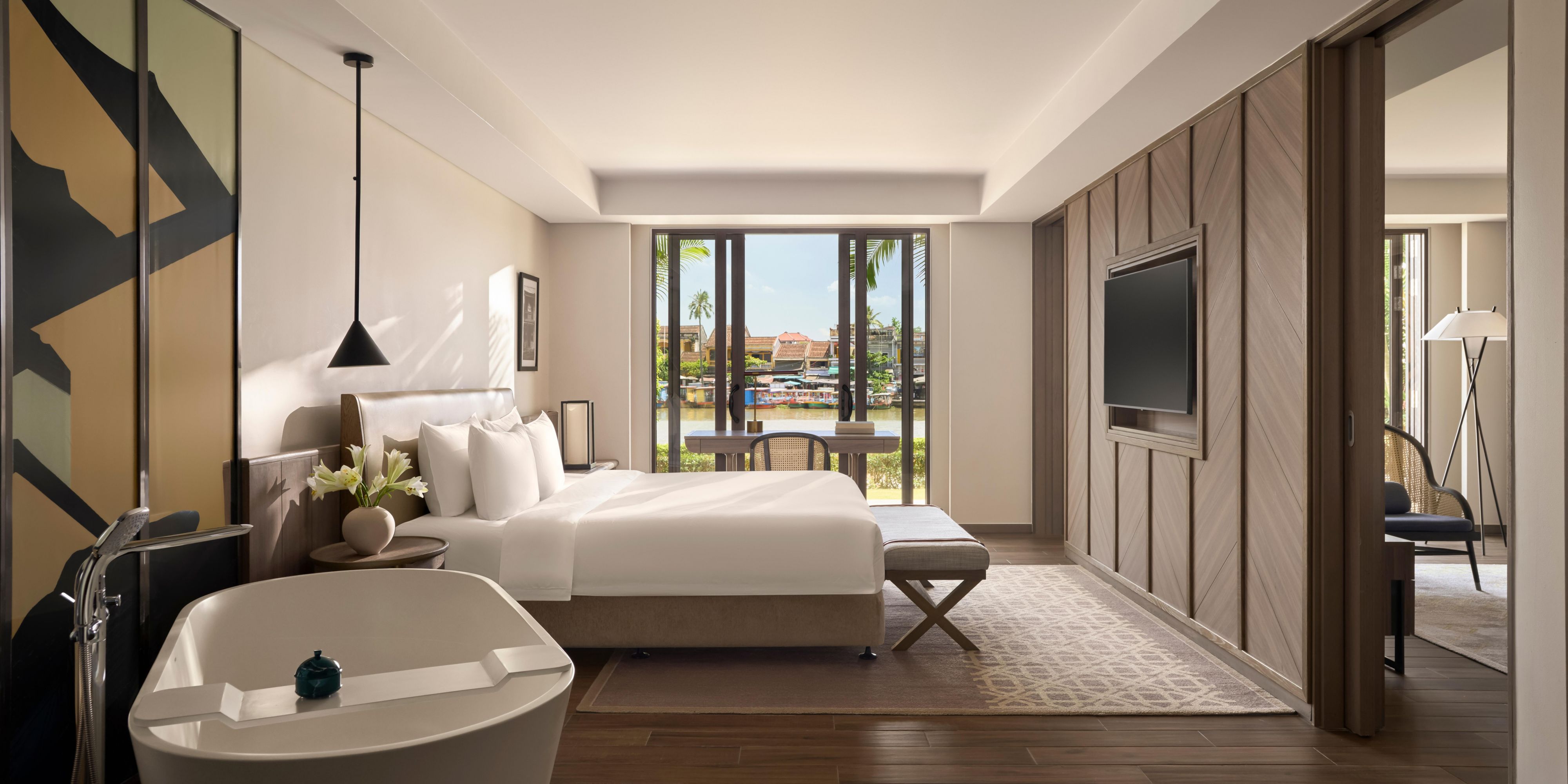 River-view suite with soft tones and elegantly layered details.   