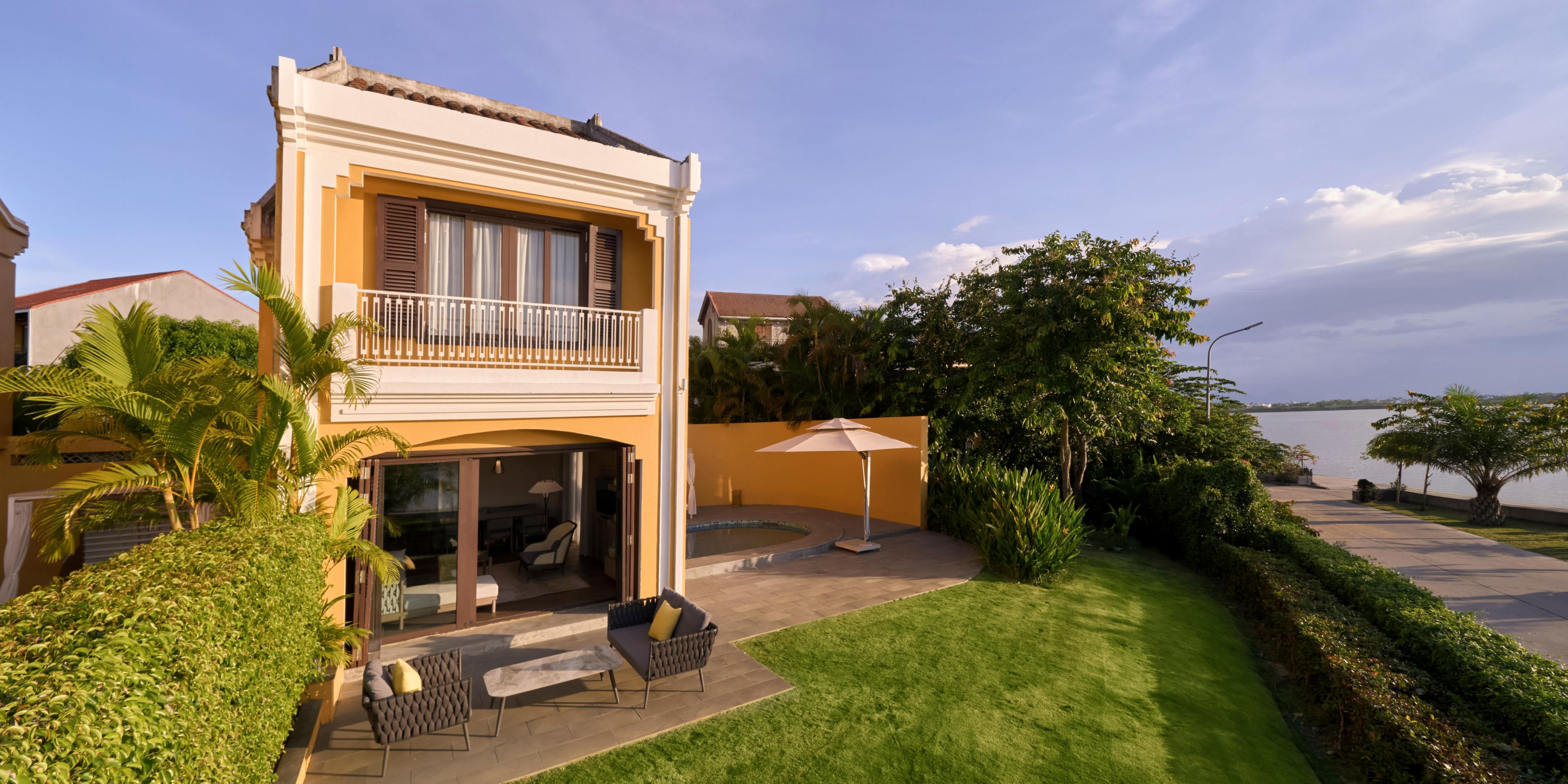 Two-story villa with private pool, garden, and riverfront view.   