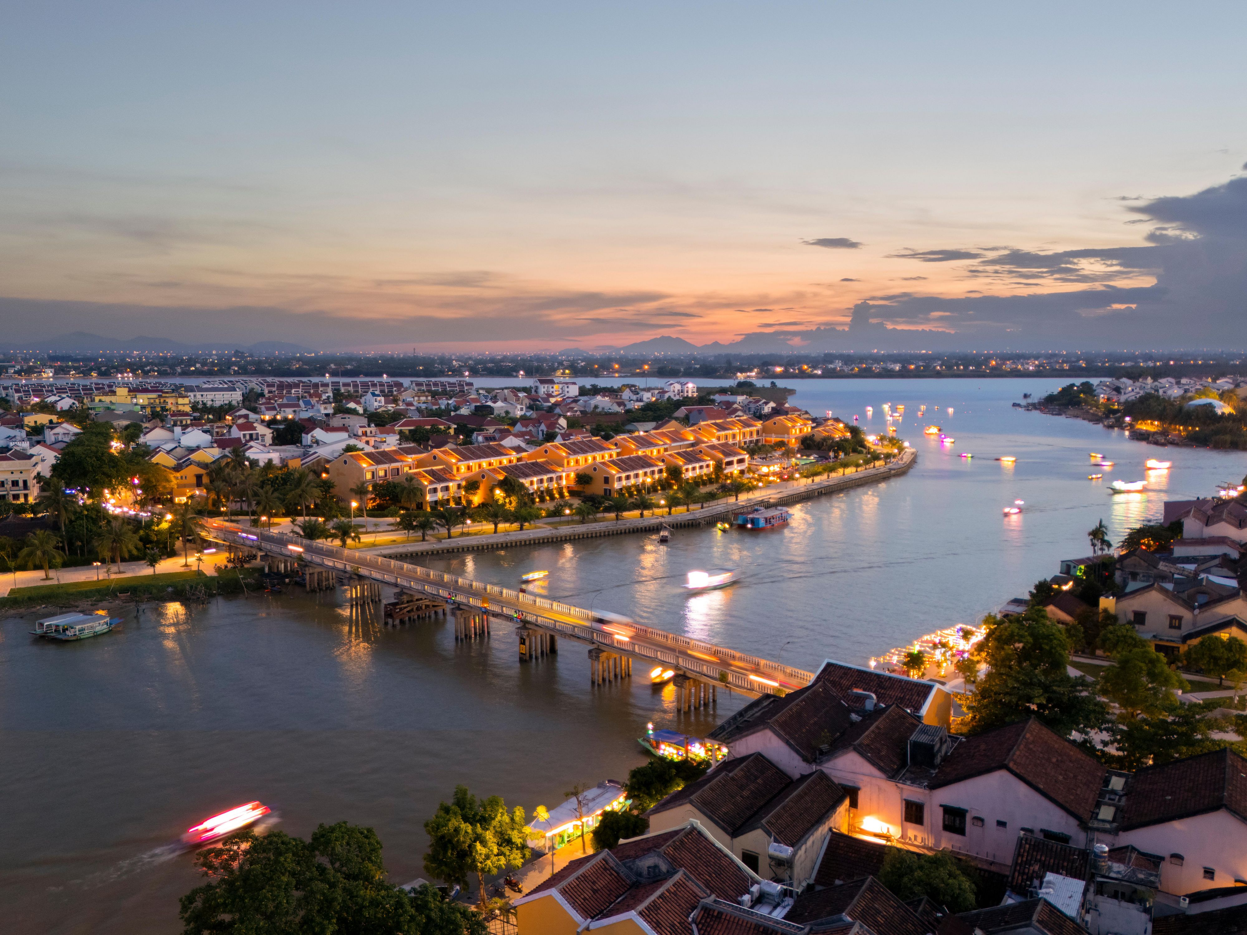 Lantern-lit Hoi An glows at sunset, with Moire nestled riverside. 