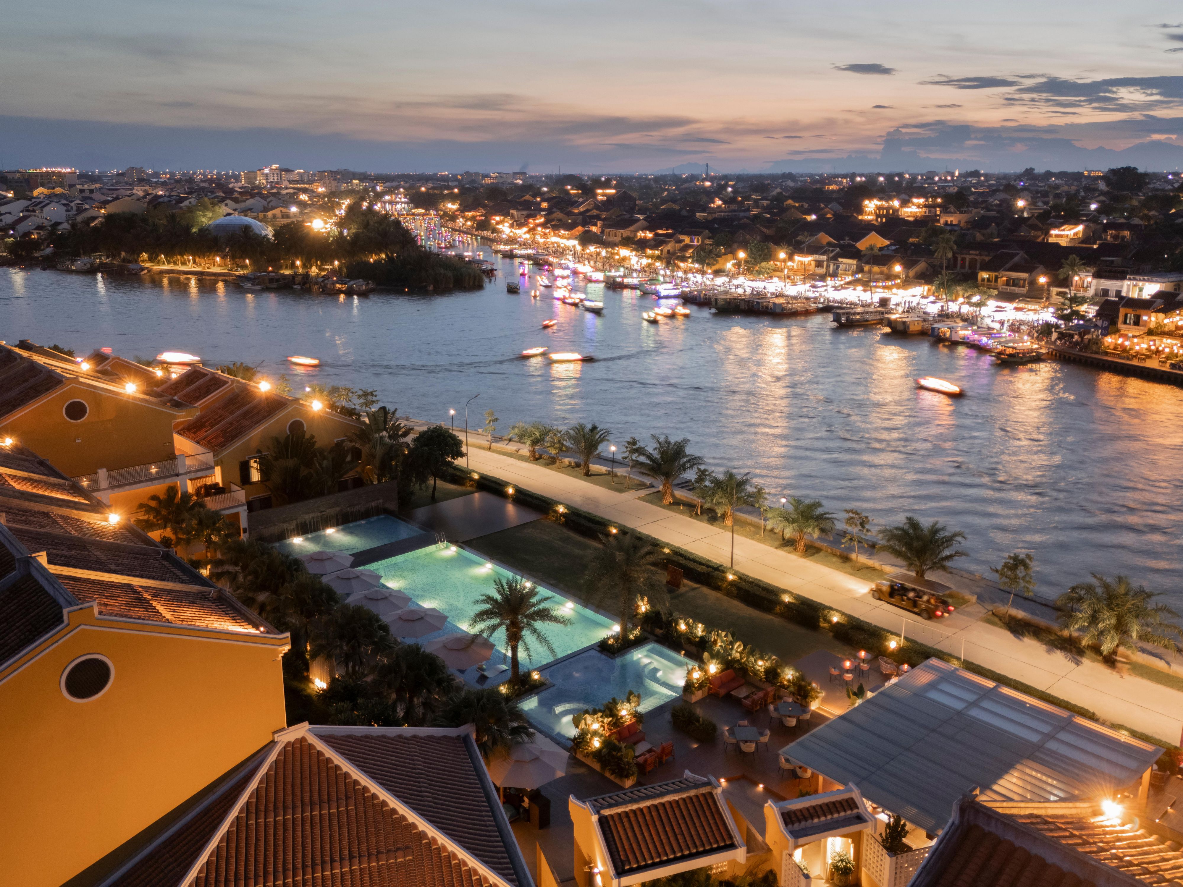 Soak in twilight magic with serene poolside views of Hoi An aglow.