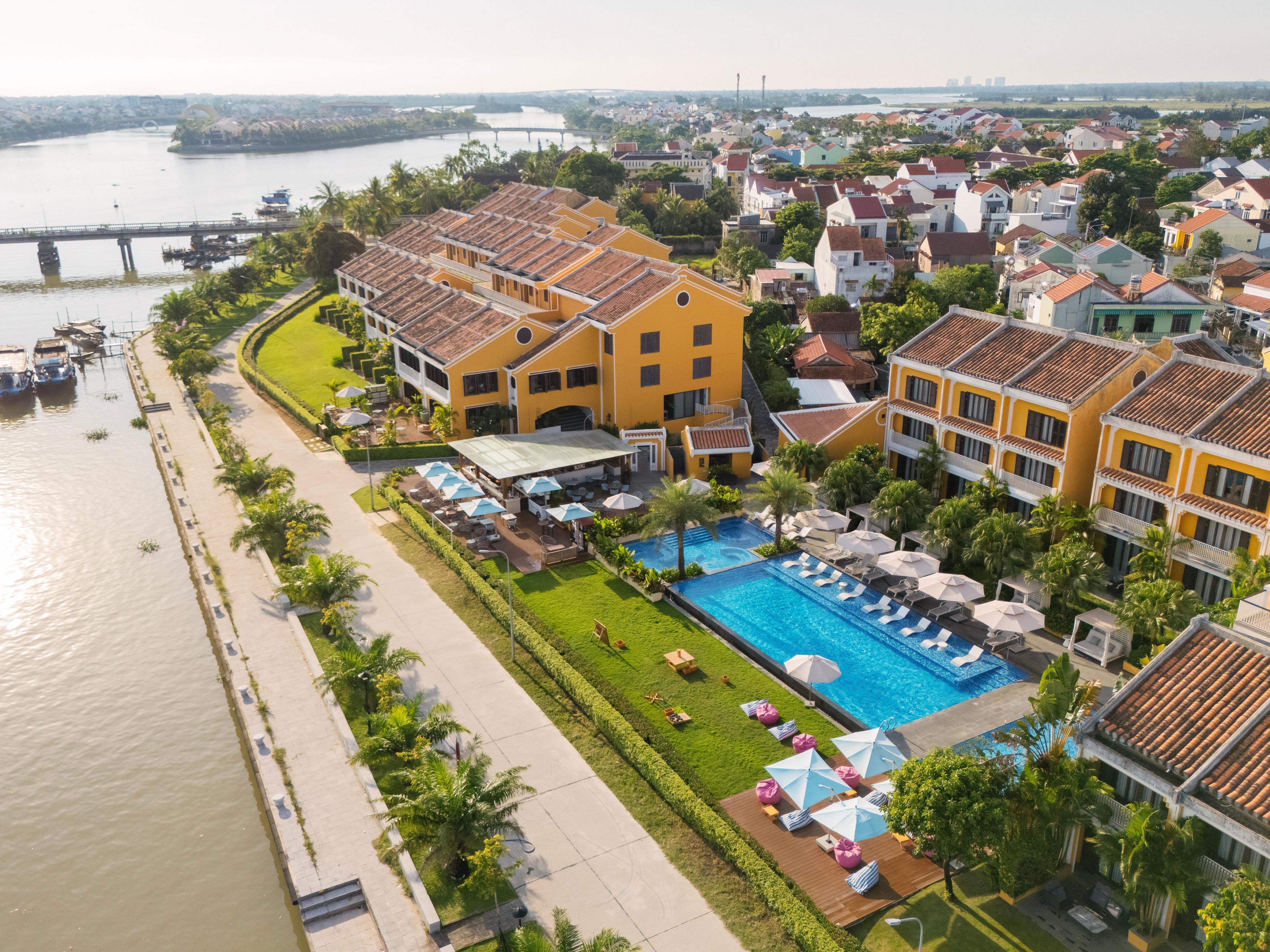 Poolside leisure meets vibrant charm along the tranquil riverside.
