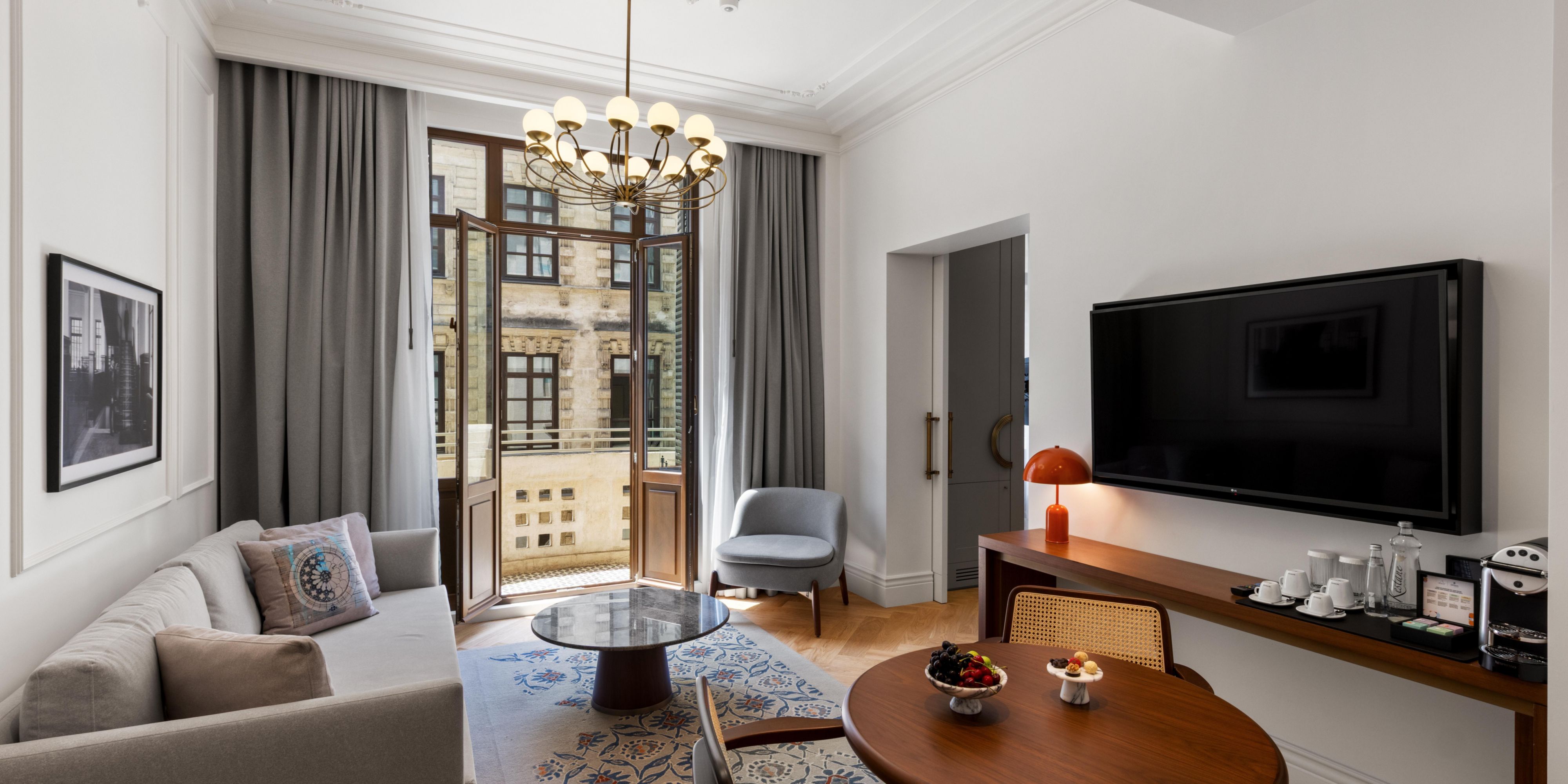Your spacious suite comes with a TV, sofas, tables and a balcony