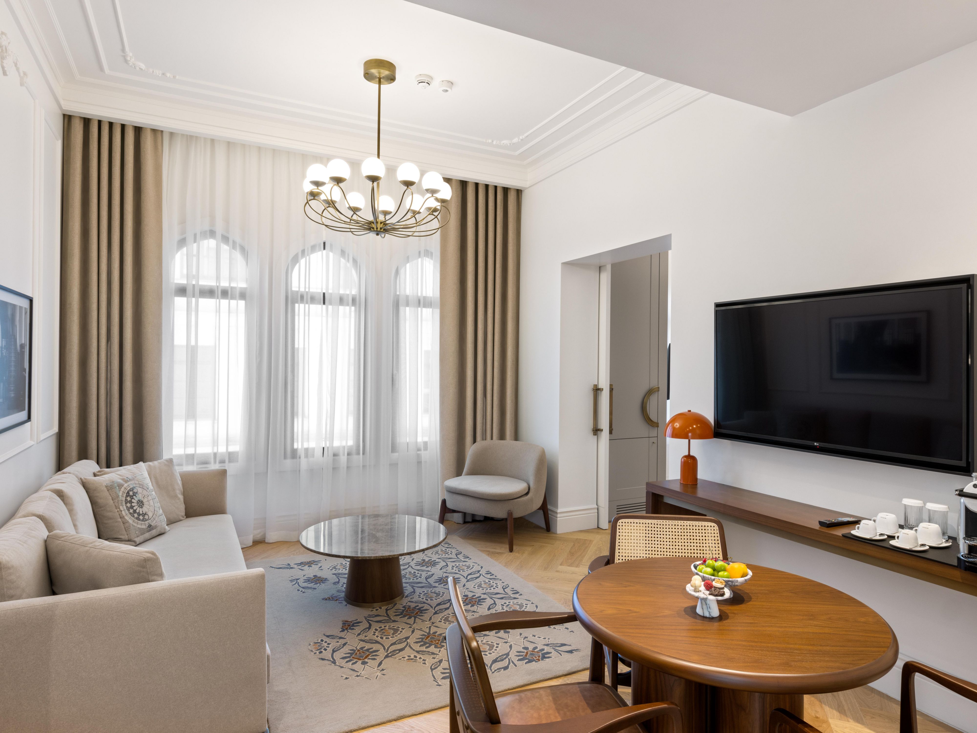 Unwind in a grand living room with soaring arched windows