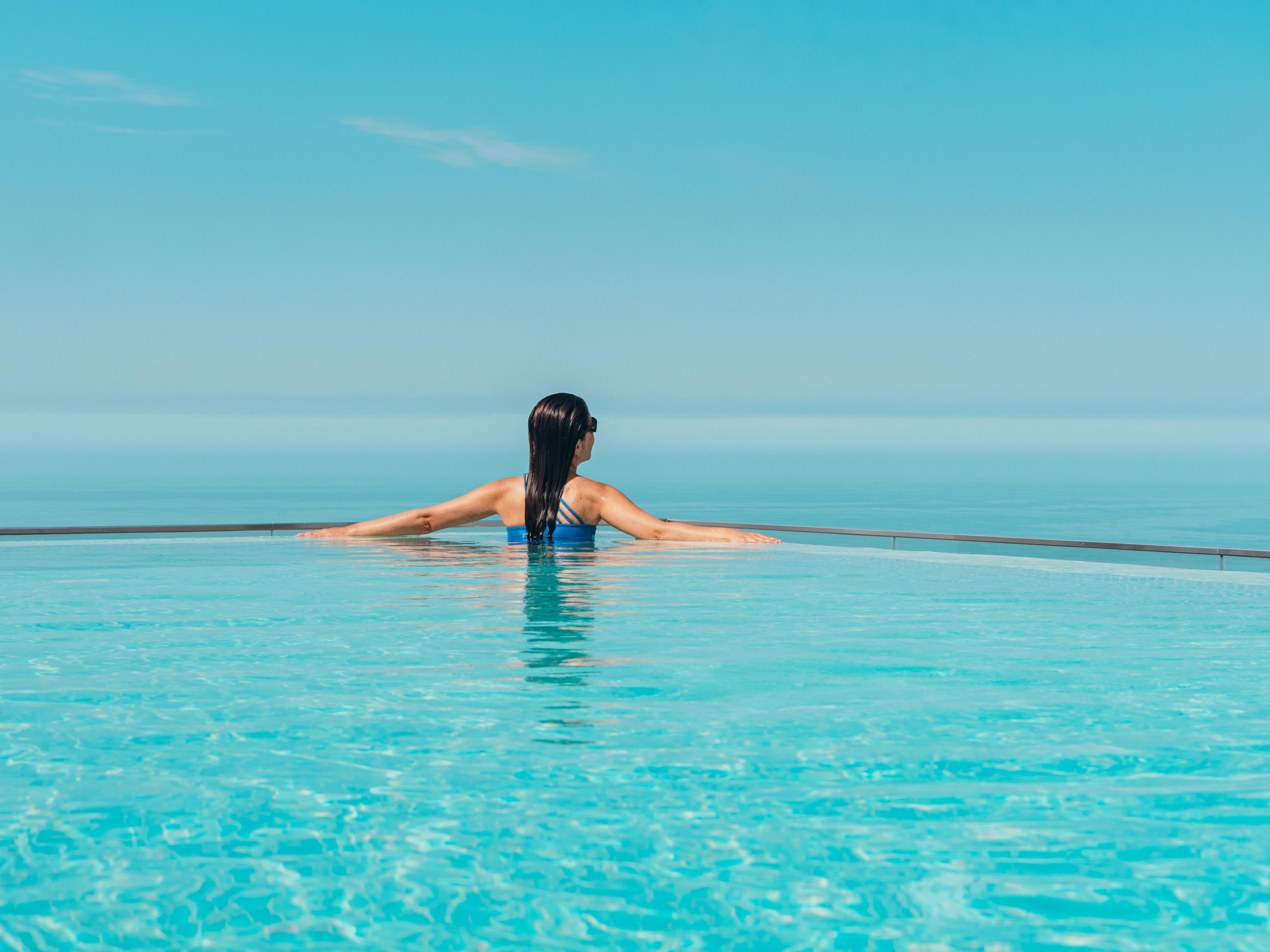 Guest enjoying the infiniti pool with a view of the ocean