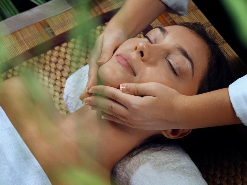 Relaxed guest getting a facial massage