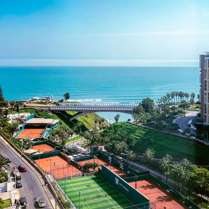 A view of costa verde with tennis courts and plenty of greenery