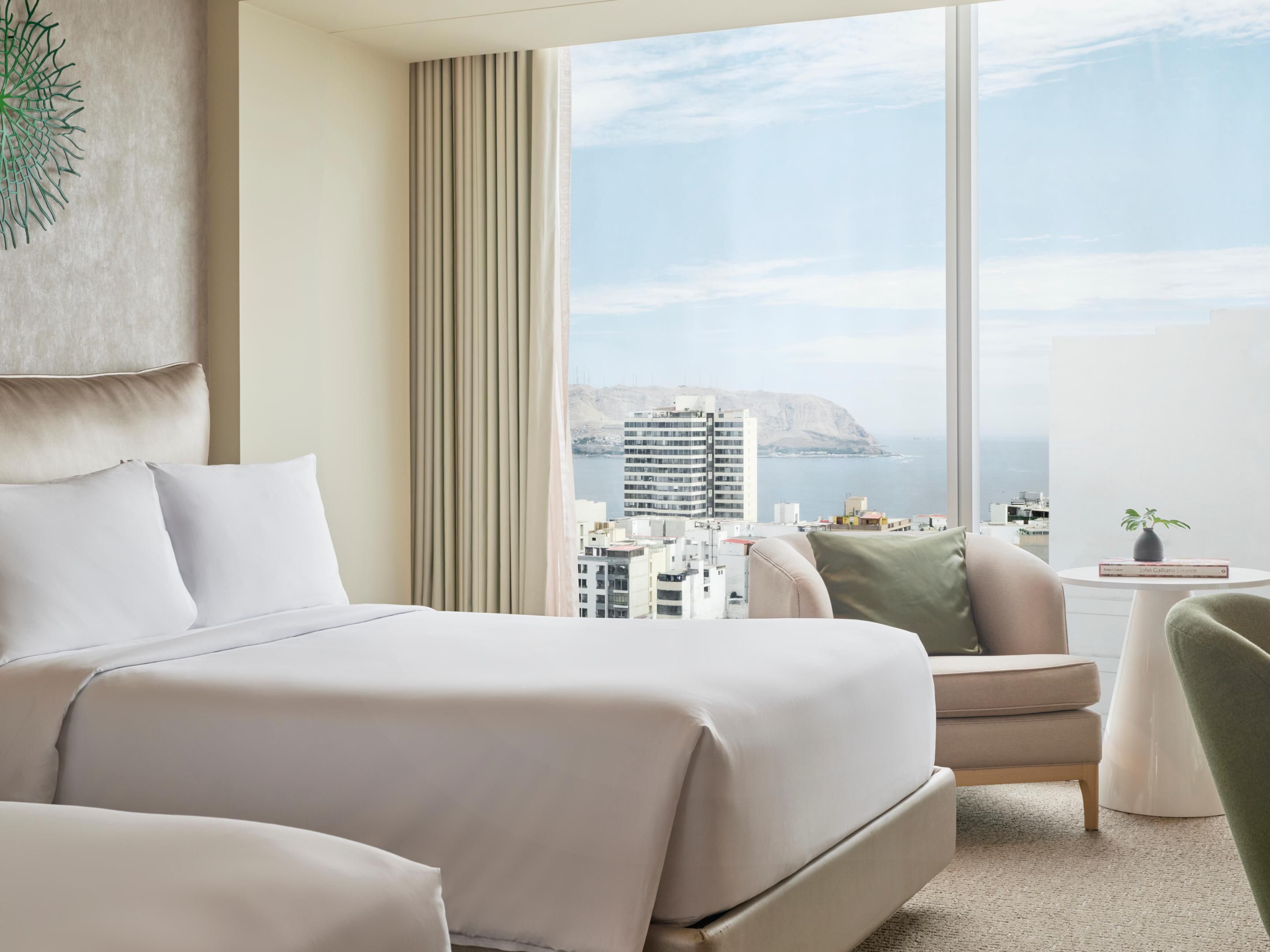 Hotel room with two double beds and a view of the ocean