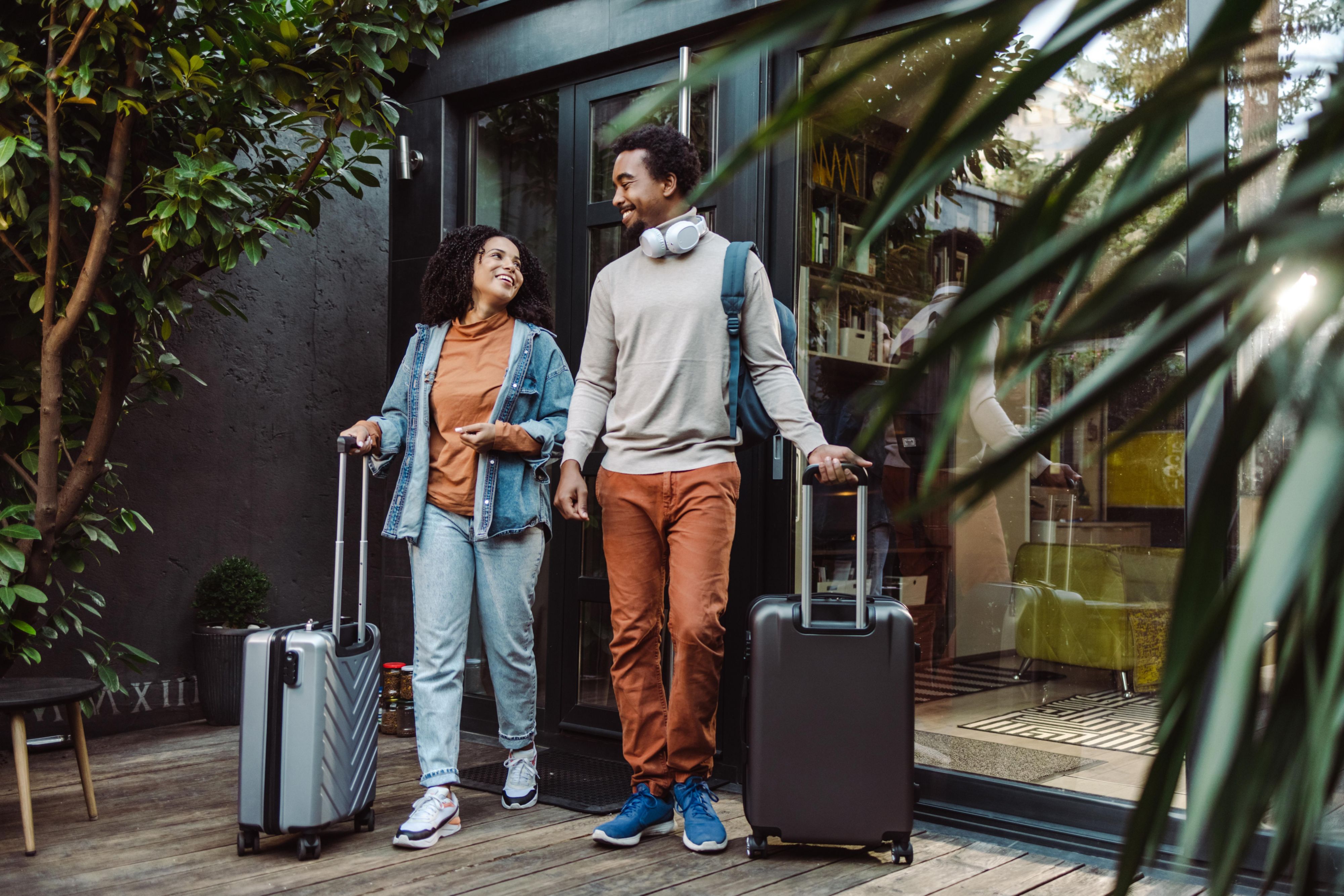 couple walking into hotel with luggage
