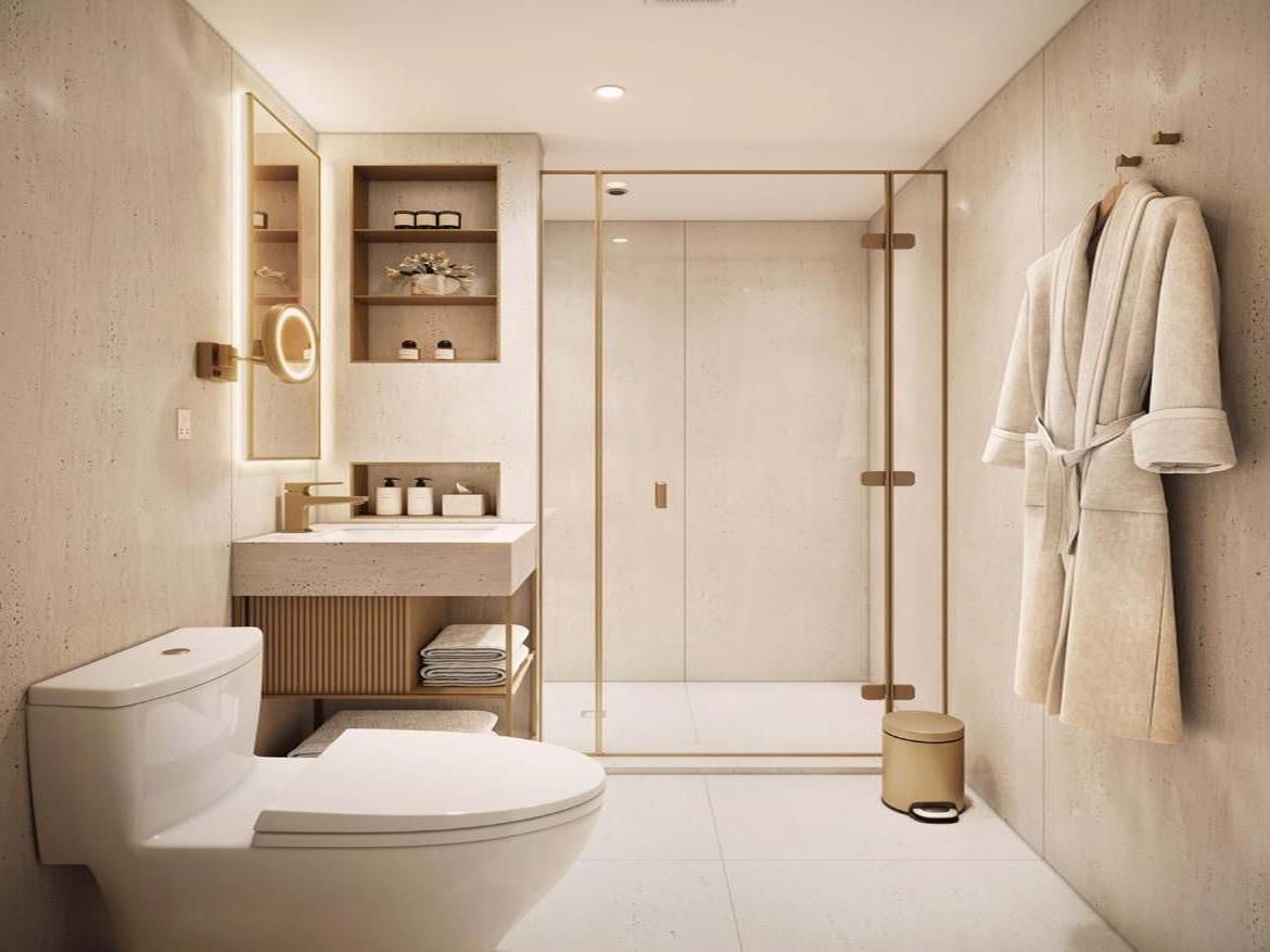 Warm stone, a fluted vanity, and soft backlight in a calm bath.