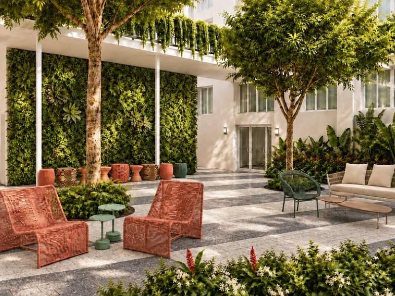 Lush Hidden Garden courtyard lounge at Bossa House Miami Beach.