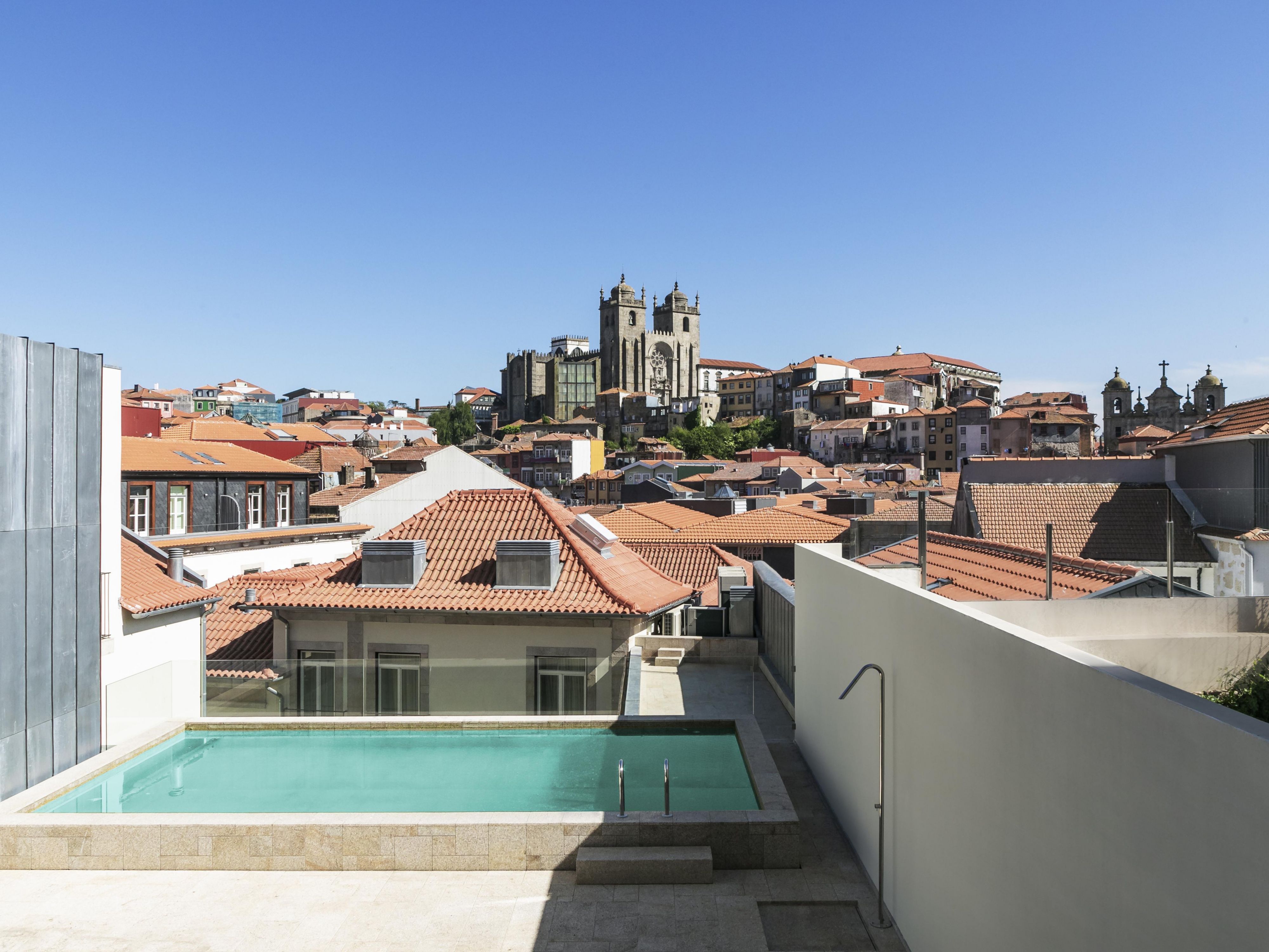 Relax by the rooftop pool with stunning Porto views.