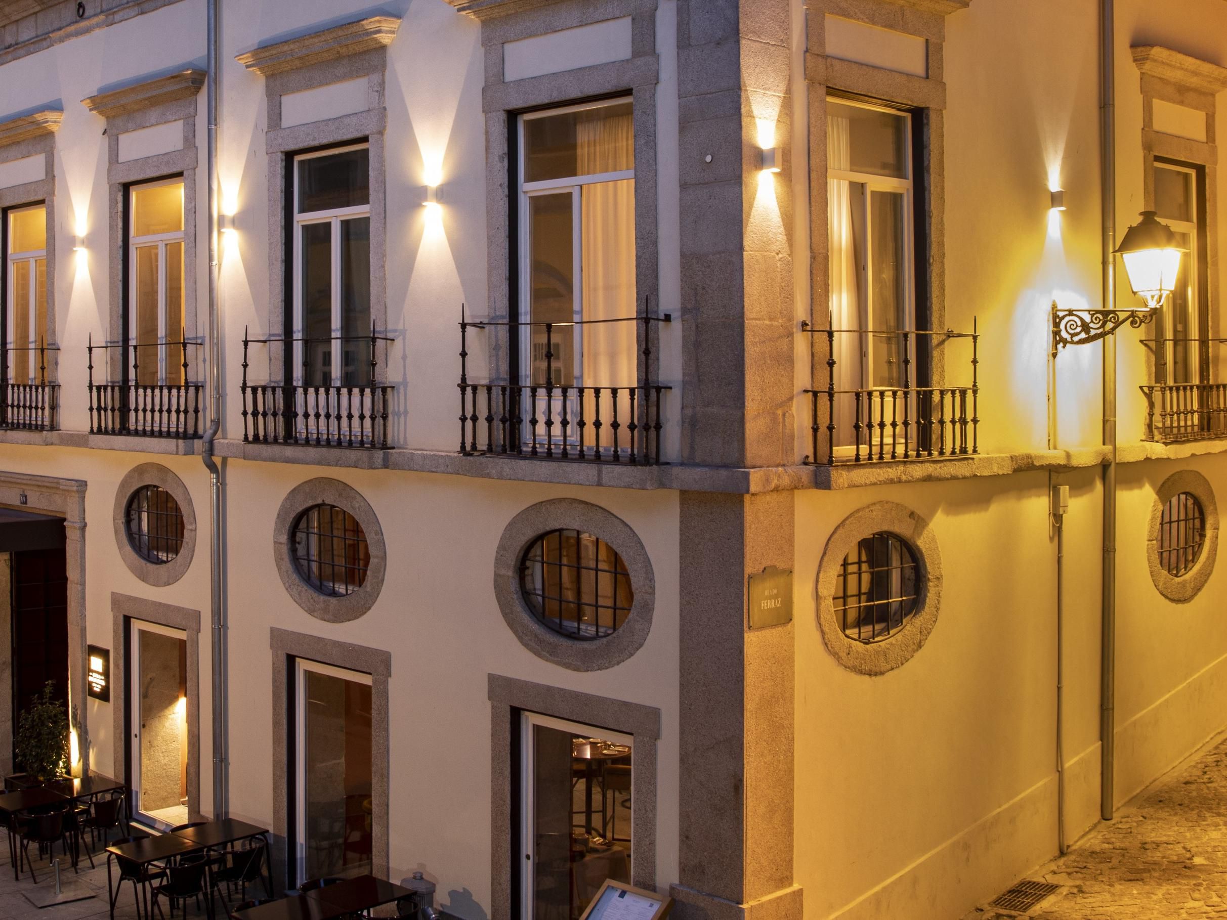 Casa da Companhia’s elegant façade glowing at night.