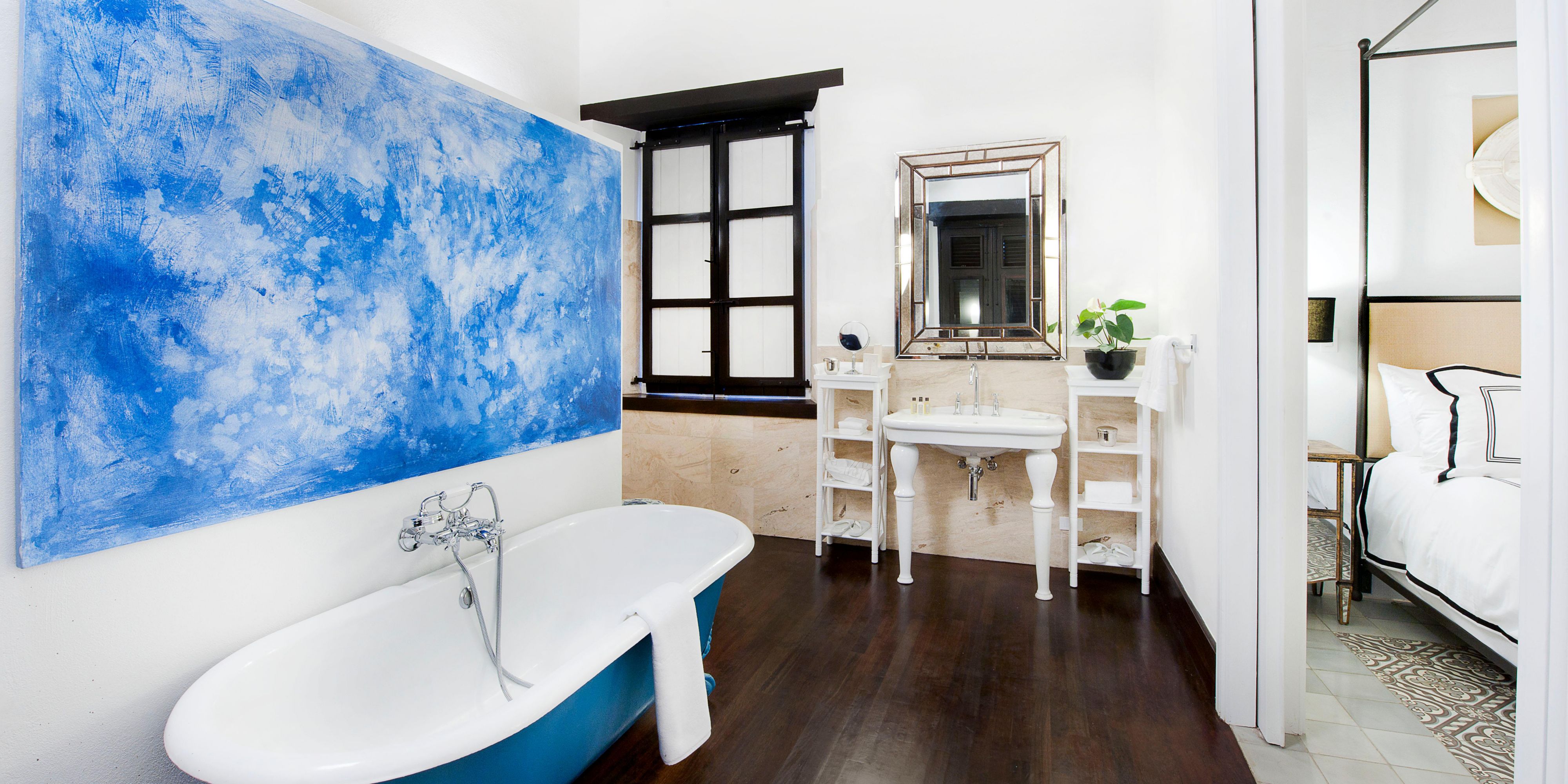 Elegant bathroom with freestanding tub and blue decor.