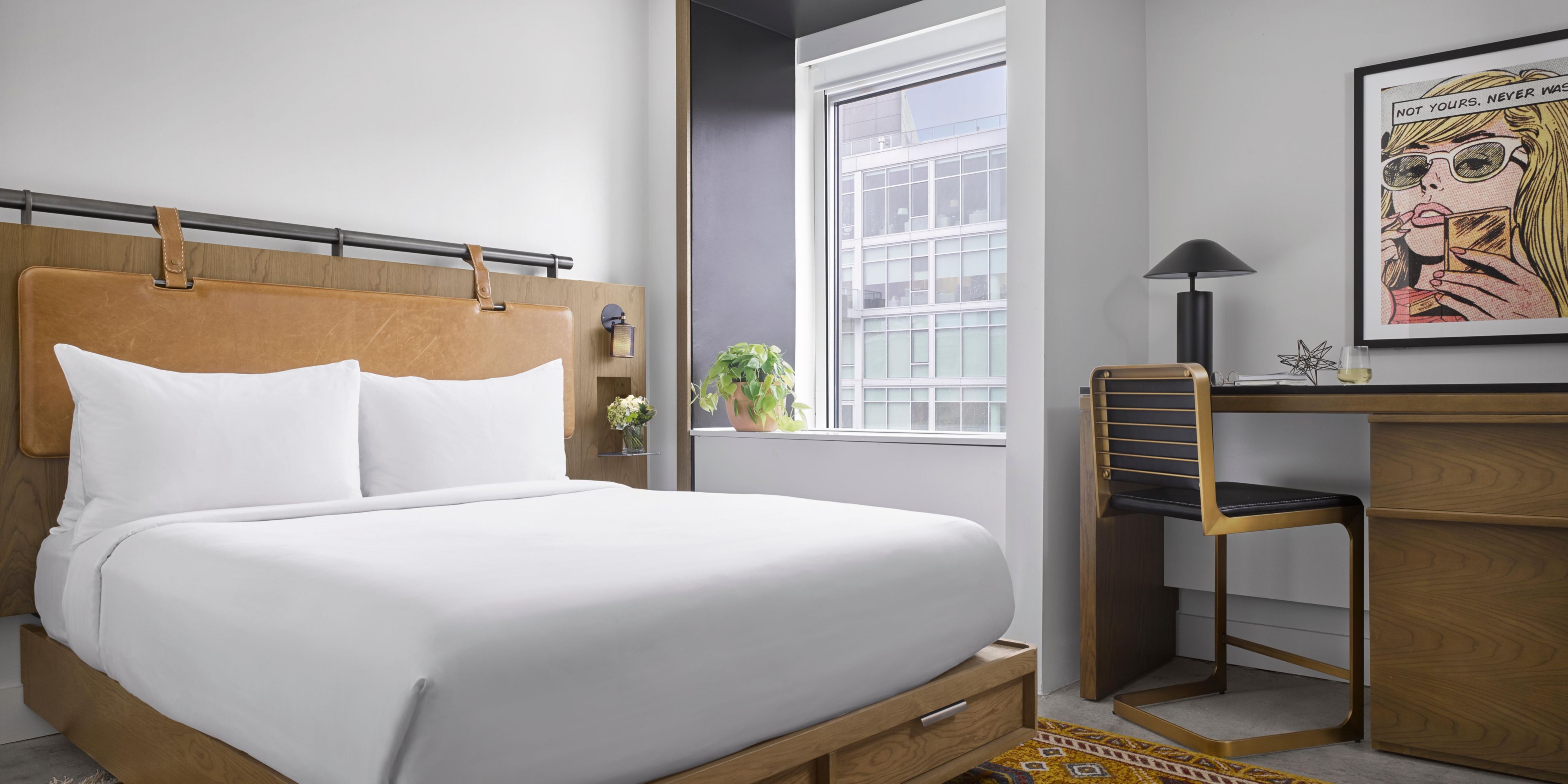 Our standard queen bed room features modern design and plush bed.
