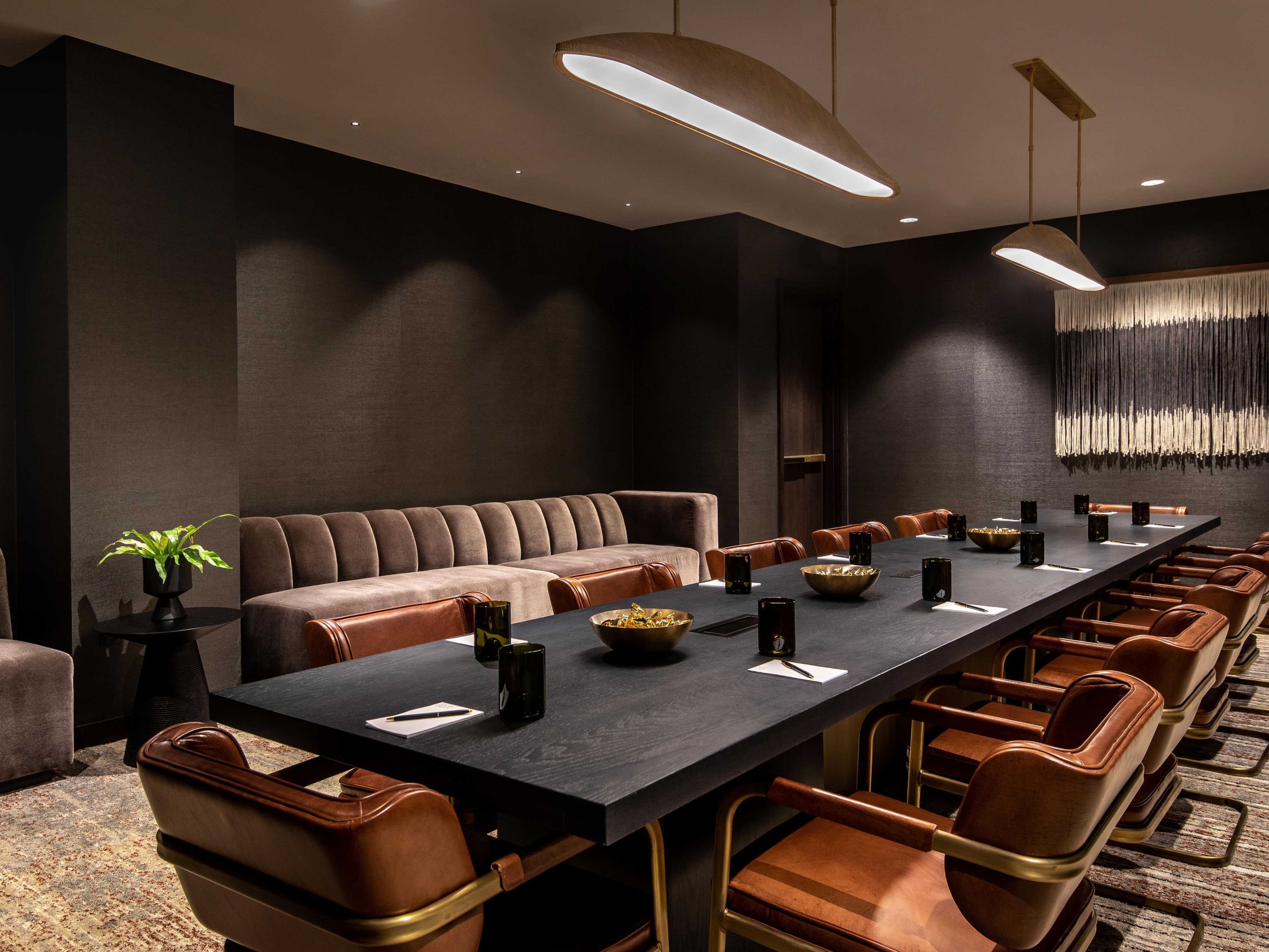 Updated meeting space featuring a boardroom table and leather chairs