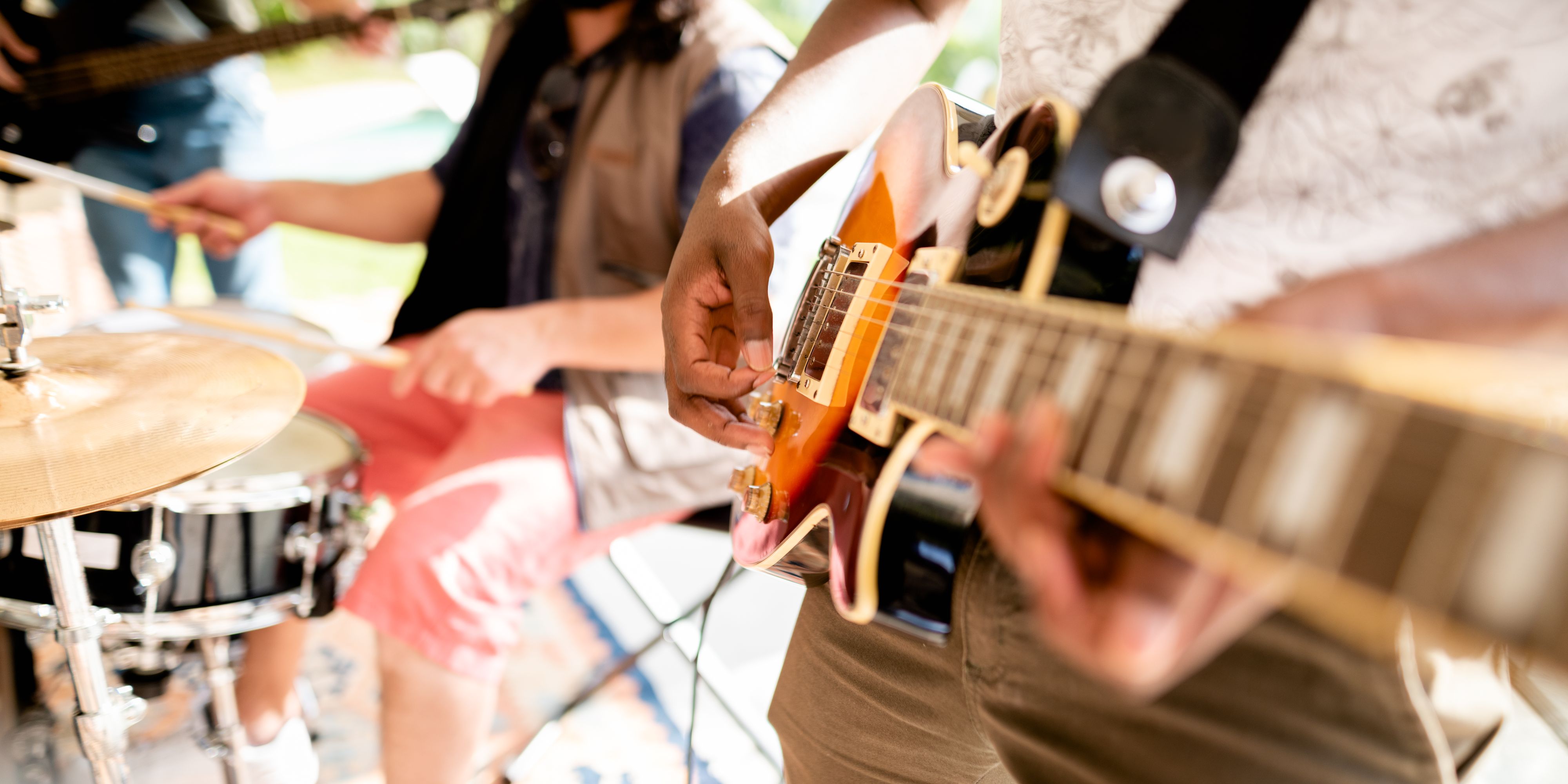 close up of band playing guitar and drums